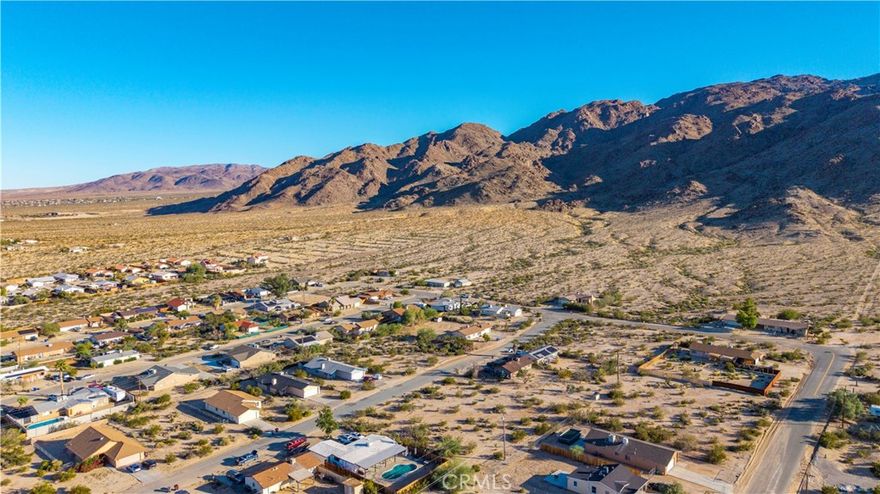 Beautiful parcel located in the sought-after Smoketree area, surrounded by attractive homes and desert scenery. This buildable lot offers stunning views of the nearby mountains and a peaceful residential setting that feels worlds away yet remains close to town conveniences. Utilities are believed to be available at the street—buyer to verify.
Enjoy proximity to Joshua Tree National Park, the Marine Corps Base, the 29 Palms Art Gallery, and the lively downtown area featuring local shops, restaurants, and community events like the Joshua Tree Music Festival and Farmers Market. Whether you’re looking to build your desert retreat, primary home, or a short-term rental, this scenic parcel offers an ideal opportunity to create your vision in the heart of the Hi-Desert.