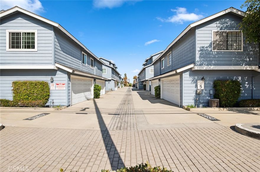 Live in the heart of Costa Mesa with this stylish 2-bedroom, 2-bath home that perfectly balances comfort and functionality. The open-concept living area flows seamlessly from the kitchen to the living room, centered around a decorative fireplace, making it ideal for relaxing or entertaining. Vaulted ceilings, vinyl plank flooring, and plantation shutters add modern flair and privacy. The main level features a full bedroom and bathroom—perfect for guests or a home office. Upstairs, the loft-style primary suite offers an en-suite bathroom and abundant storage, creating a serene private retreat. Enjoy the convenience of an attached 2-car garage with epoxy flooring, extra storage, and a washer/dryer setup. Central A/C ensures year-round comfort. Located close to Mercado Market, trendy eateries, and just minutes from Fashion Island and South Coast Plaza, this home puts shopping, dining, and entertainment right at your doorstep. Not to mention, everything Costa Mesa has to offer is just a short drive away!