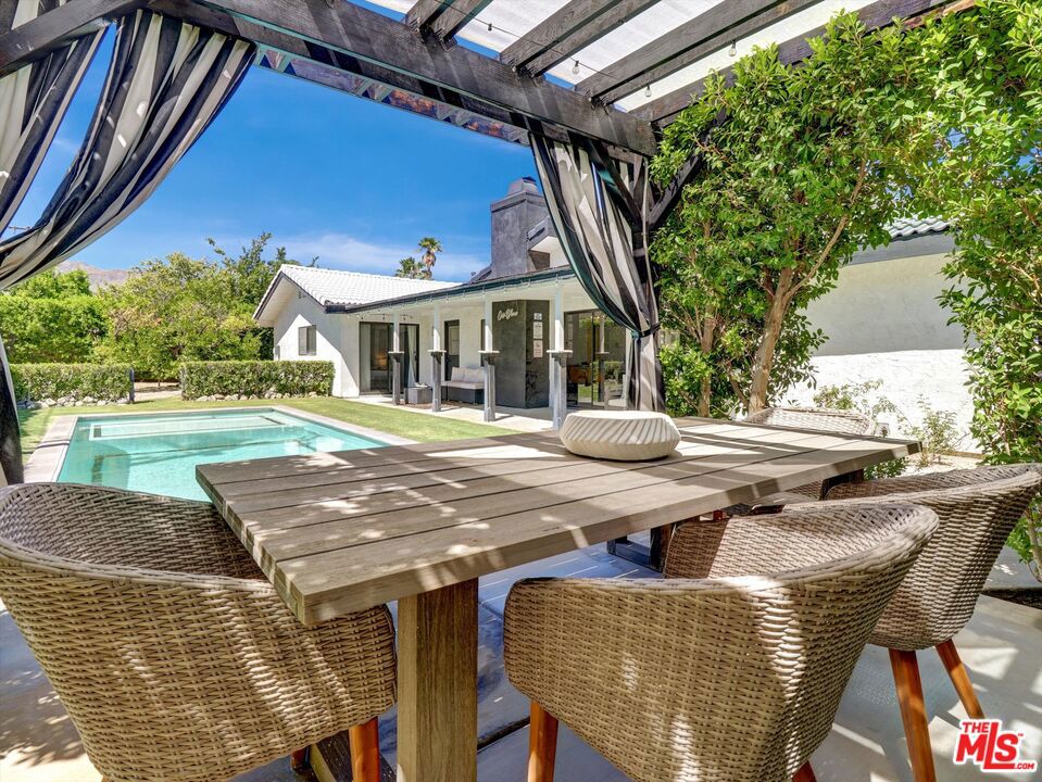 This recently renovated Spanish modern residence is perfectly located in the heart of Palm Springs, nestled in the peaceful Desert Park Estates neighborhood. The home has been carefully maintained and thoughtfully upgraded. Its tranquil, resort-style yard ensures complete privacy, featuring an updated pool with a sun deck, concealed water features, and a custom pergola, all framed by stunning views of the San Jacinto mountains. Inside, the chef's kitchen is a culinary delight, boasting a 48-inch Wolf commercial-grade gas range with six burners, a griddle, double ovens, and a high-quality hood. It also includes a spacious side-by-side refrigerator and freezer, enhanced by custom cabinetry and countertops. The generous open floor plan is ideal for both entertaining and relaxation, showcasing high ceilings, elegant high-gloss Spanish tiles, and a dedicated space perfect for a home office or cozy reading nook. The expansive primary bedroom offers direct access to the pool and features a large walk-in closet. The luxurious primary bathroom includes a walk-in shower and custom cabinetry and fixtures that impress. Additional features include a new A/C system installed in 2021, an efficient evaporative cooler added in 2022 to help lower energy costs, and a new hot water heater. With five ceiling fans throughout, comfort is assured. Situated on a spacious corner lot, away from the bustle of Farrell Dr., this property is a must-see.