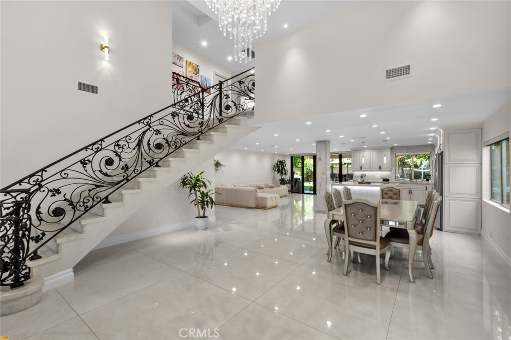 Welcome to this stunning two-story residence in the heart of Tarzana, offering the perfect balance of elegance, comfort, and functionality. This spacious 5-bedroom, 4-bathroom home boasts approximately 2,611 square feet of thoughtfully designed living space with impressive vaulted ceilings and sleek tile flooring throughout the main living areas.
The layout features one bedroom conveniently located on the first floor—ideal for guests or multigenerational living—while the remaining four bedrooms are upstairs, including a beautifully designed primary suite with a private balcony. The kitchen and living areas are open and bright, perfect for both everyday living and entertaining. The garage can easily be converted to an office space or ADU.
Outdoors, the backyard is a true retreat, offering a lush tropical ambiance with an attached covered patio, built-in barbecue station, cozy fire pit, and a serene koi pond. Located in a charming and established neighborhood, this home is just moments from highly rated schools, popular shopping destinations, dining, and convenient freeway access. This is an exceptional opportunity to own a thoughtfully upgraded home in one of Tarzana’s most sought-after areas.