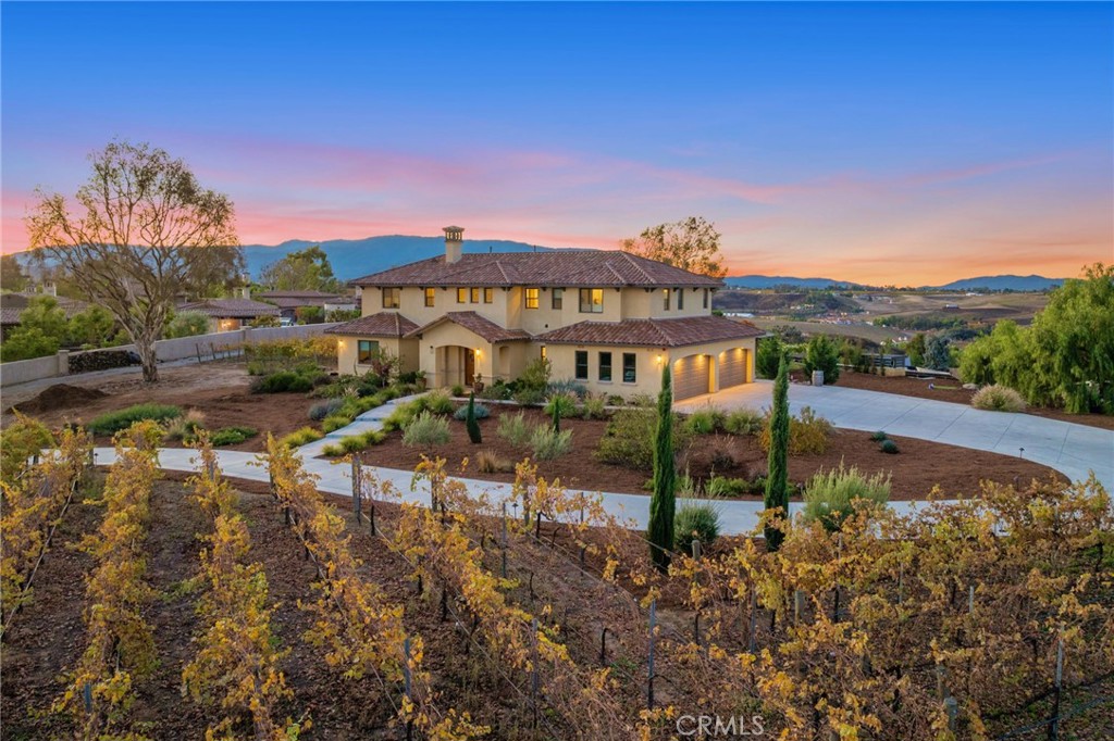 RARE opportunity to own not ONE but TWO Tuscany inspired homes perched high on a hill offering STUNNING views from every angle. Perfectly situated on just over 2 acres these Temecula wine country homes are dripping with old world sophistication. Cul-de-sac location means little to no traffic. The security gate at bottom of the driveway makes for a DRAMATIC ENTRANCE, leading you to up to the estate, passing vineyards and 3-bedroom residence on the right bringing you to the 4-bedroom main residence on your left. Main house offers a brand-new custom pool with smooth pebble tech coating & Lunada bay glass tile complimented by a 10 person spa. Have THE BEST soirée with your own custom wood fired pizza oven, outdoor wood burning fireplace & gas firepit. Step through the custom knotty Alder entry doors and notice the soaring ceilings while taking in the breathtaking valley views through the solarian windows past the pool, spa and firepit. Formal dining room sits in the Solarian window setting perfect for evening entertaining and taking in the valley lights. Just off the GREAT room adorned with a fireplace, you’ll find a spa inspired junior suite with a full bath opposite the office and downstairs powder room. Kitchen features high end appliances & finishes offering side-by-side Subzero fridge, Wolf range oven, 2 Bosch dishwashers, Wolf microwave, Kohler faucet, Cambria Ella quartz island counter w/contrasting quartz counter, & handmade Spanish Subway tile backsplash. Upstairs, a secondary private family room, separating the generous Primary Bedroom & Bath from 2 additional Bedrooms and Baths. Just off the family room, an OVERSIZED balcony w/ INCREDIBLE VIEWS overlooking the tranquil vineyard. Flooring upgrades include Colonial Collection European oil finish Oak, Custom American Oak stair treads & a combination of Quartz, Marble & Granite throughout. In addition, custom wood cabinetry, solid core interior doors, Dual System high efficiency AC units, whole house attic fan, Santa Barbara smooth stucco, Gas burning fireplace w/flagstone facade w/ custom live edge oak marble, authentic clay roofing, and sound system. 2ND home offers 3 beds/3 baths~situated offering sweeping views of San Jac mountains w/Stainless Steel appliances, Quartz counters, & fire pit. Drip irrigation means annual water bill <than 1700.00 for both homes. 40 owned Solar covers most if not all usage. Extended driveway actually does a full circle around the property. FIRE SPRINKLERS AT BOTH HOMES.