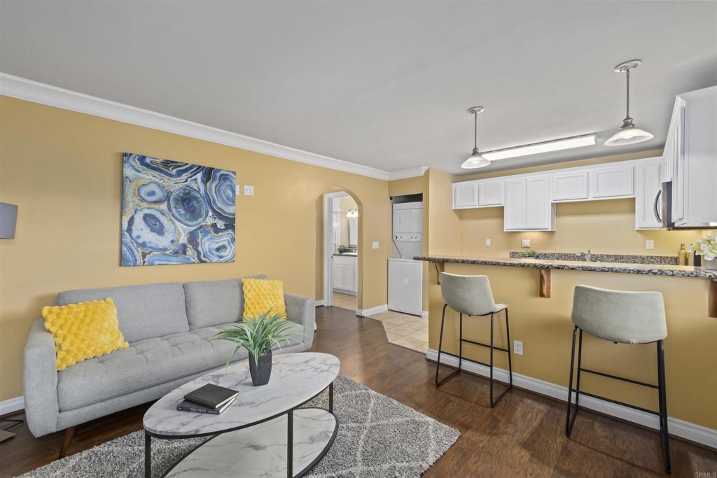 Step into comfort and style in this beautifully updated 1-bedroom, 1-bath condo nestled within a secure gated community—where convenience meets resort-style living. From the moment you enter, you'll love the open, functional layout and the warm ambiance created by rich engineered wood flooring in the living area—perfect for cozy nights in or entertaining guests with ease. Enjoy access to a sparkling pool, soothing spa, and a fully equipped gym—your personal wellness retreat just steps from your door. Located just minutes from major freeways, shopping, dining, and entertainment, this home offers unbeatable convenience without sacrificing peace and privacy. Whether you're a first-time buyer, downsizing, or looking for a low-maintenance lifestyle, this charming condo checks all the boxes. Come experience effortless living in a community that truly has it all!