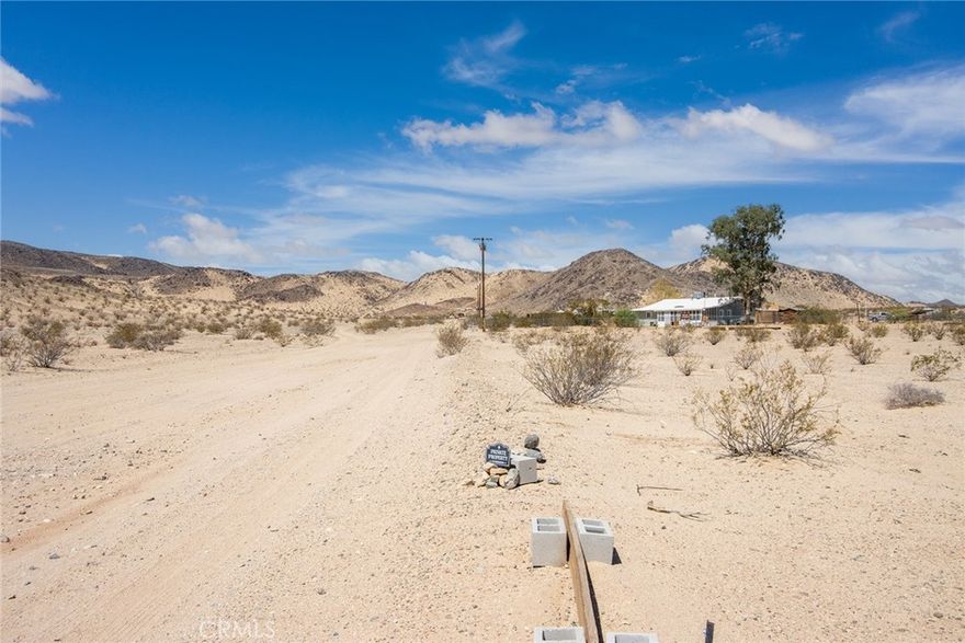 5 BIG ACRES of Land in established area with utilities in the street. Remote & Rural, yet close access to paved Leer Rd. Great opportunity to build a home or buy as an investment to hold as prices rise in the future - get in while parcels are still affordable. Only a short drive to the Indian Cove entrance of the Joshua Tree National Park. Or just hike from this property into the vast surrounding wilderness. Property is located about halfway between the downtowns of Joshua Tree & 29 Palms. 29 Palms is currently undergoing a resurgence, with new restaurants, a new brewery and vibrant activity. This property already has an official street address - the first detail needed before one can apply for permits. Great property, great location!