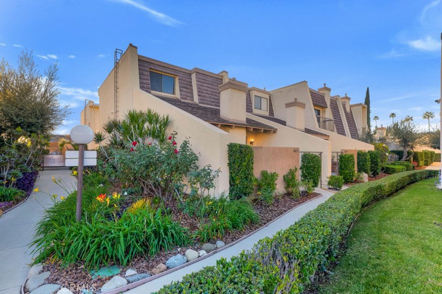 Set within the gated Tarzana Villas North community, this tri-level 2-bedroom, 2.5-bath, 1,512 sq ft townhome has been completely redone from top to bottom, offering a bright, light, and contemporary living experience with no detail overlooked. Low HOA dues, only $460 per month!  A private front courtyard leads into a split-level living space highlighted by soaring vaulted ceilings, a striking wood beam, smooth ceilings, fresh paint, brand new flooring, and all-new lighting throughout. The lower living area is anchored by a fireplace with a modern tile surround and sliding glass doors opening to the front patio, creating an easy indoor-outdoor connection. A short flight of stairs leads to a versatile secondary level ideal for dining or additional living space, featuring breakfast bar seating and a passthrough to the brand-new kitchen. The kitchen showcases quartz countertops, recessed lighting, and all-new appliances, and flows seamlessly into an adjacent informal dining area and generous family room complete with a built-in wet bar, perfect for entertaining. A conveniently located powder bath completes this level. Upstairs, brand new carpet leads to two spacious en-suite bedrooms, including a sizable primary suite with a walk-in closet, updated ¾ bath, and tranquil views overlooking the community pool. The secondary bedroom features a mirrored closet and an updated en-suite full bath. Additional highlights include a private direct-access 2-car garage, thoughtful modern finishes throughout, and access to resort-style living with amenities such as a pool, spa, rec room, and more, all in a prime Tarzana location close to shopping, dining, and major thoroughfares. Don’t miss out on making this your new home!