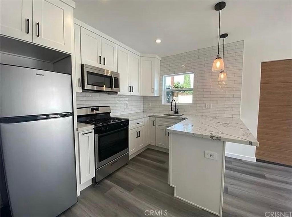Discover this beautifully designed 1 bed, 1 bath ADU featuring private front and back entrances, located in the heart of Winnetka. Enjoy the convenience of in-unit stackable laundry, split system A/C, and gated parking with an additional side yard for extra space or storage. laminate flooring, recessed lighting. Beautifully updated kitchen featuring sleek quartz countertops and modern finishes. Enjoy the added benefit of a private front yard, ideal for relaxing or entertaining. Great and quiet neighborhood. Located in a highly desirable area, just minutes from Westfield Topanga, The Village, Pierce College, premier dining, movie theaters, shopping destinations, and easy access to the 101 Freeway. This bright and efficient unit offers modern comfort and privacy.