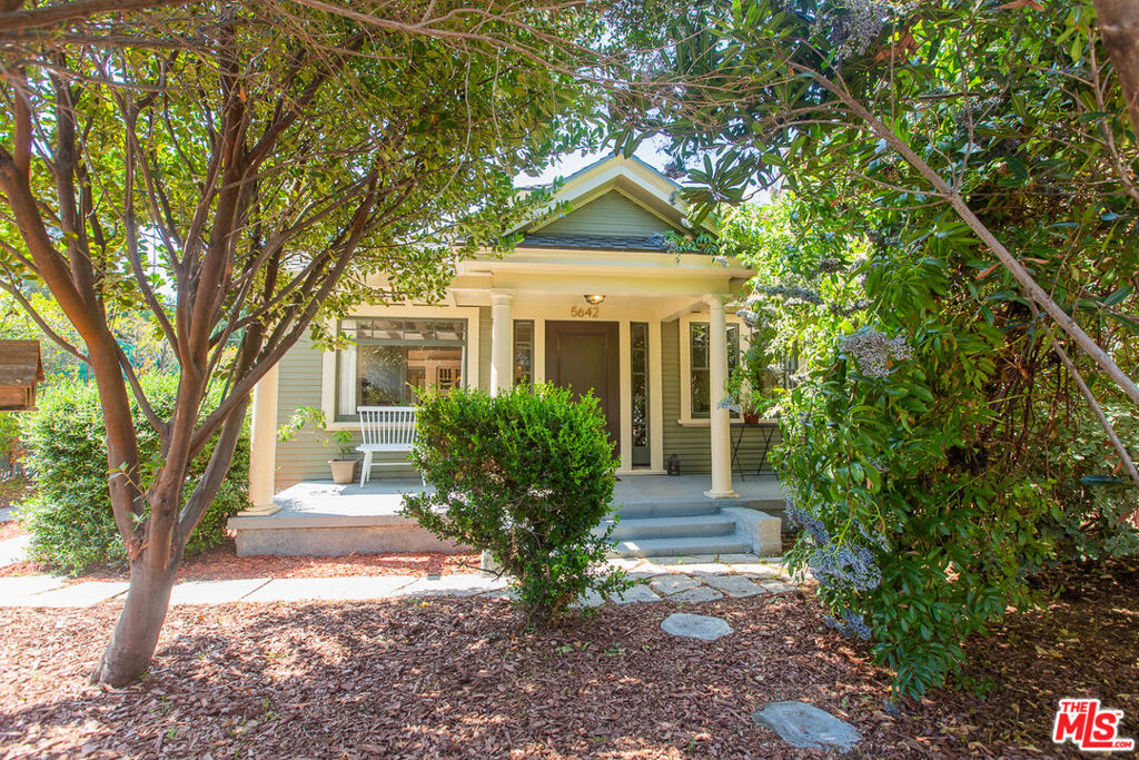 Charming Craftsman Bungalow c. 1918. This lovingly restored character-laden gem is a hidden oasis, centrally located near the Hollywood studio corridor, just south of Los Feliz. Featuring 2 spacious bedrooms, 1.75 baths, and a large convertible den with backyard access that could easily be a 3rd bedroom. Note: tax records show 2 bedrooms. and 2 baths. Spacious open living room with 2 sets of original built-ins and a custom fireplace. Formal dining room with an original sideboard and period chandelier. Remodeled kitchen with marble countertops and custom cabinetry, additional pantry leads to laundry area, and direct access to the outdoors for easy entertaining. Hardwood floors throughout, newer wood windows, picture rails, period sconces. French doors in the den with matching wood frame screens. The primary suite features a cozy reading nook and a renovated 3/4 bath. ample closet space, garden views, and its own set of French doors to the backyard. Expansive, canopied grounds filled with fruit trees, native plants, and herbs. The perfect setting for outdoor relaxation or gardening. Updated systems include plumbing, electrical, and foundation. The converted garage serves as a bonus room, office, or studio. Sited on an approx. 6,700 sq ft. fenced and gated R3 lot. Close to all major thoroughfares, shops, and restaurants, including the exciting new $450 million Echelon Studios Project currently underway, just a few blocks south. A truly enchanting find in the middle of it all.