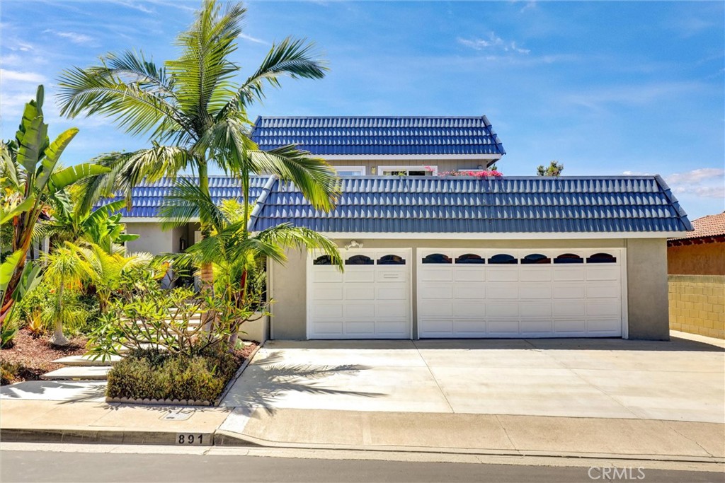 Tucked behind the gates of the prestigious Bixby Hill community lies this luxurious entertainer’s dream home, where timeless elegance meets modern upgrades in one of Long Beach’s most desirable neighborhoods. This luxurious 5-bedroom, 4-bathroom residence offers 3,293 sq ft of refined living space on a beautifully landscaped 10,641 sq ft lot, thoughtfully designed for comfort, entertaining, and multigenerational living. From the moment you step inside, you’ll feel the exceptional blend of elegance and functionality. The split-level floor plan features a main level with a formal living room, formal dining area, and a fully remodeled chef’s kitchen. Outfitted with high-end finishes, the kitchen boasts soft-close drawers and full pull-out cabinetry, topped with exquisite granite counters. The premium LG Studio appliance package includes double ovens, a 5-burner electric cooktop, dishwasher, and stainless-steel refrigerator, perfect for entertaining. Just off the kitchen, you’ll find a beautifully designed BBQ area and a serene sitting space, ideal for outdoor dining or unwinding in the peaceful surroundings. A spacious lower level features a large family room, wet bar and 2 additional bedrooms ideal for a mother-in-law suite, complete with a private kitchenette. Upstairs, two additional bedrooms look out over the resurfaced upper private deck, offering tranquil views and a seamless indoor-outdoor connection. Enter through double doors to the oversized primary suite, a luxurious retreat featuring a walk-in closet, private in-suite laundry, and a spa-like bathroom, perfectly designed for relaxation and convenience. Step outside to your private sanctuary backyard, newly landscaped with custom hardscape, a spacious 12-person jacuzzi, built-in custom fire pit, gazebo, and string lighting that sets the mood for evenings under the stars. Whether you're hosting a summer gathering or enjoying quiet nights in, this backyard is a true entertainer’s dream. The home features a long list of modern upgrades, including a newer roof, newer exterior/interior paint, newer windows, newer hardwood floors, upgraded HVAC system, insulated copper plumbing, solar panels, and resurfaced upper deck. Located directly across from California State University Long Beach and within walking distance to the Carpenter Performing Arts Center, this prime location offers the best of education including SATO Academy, culture of Rancho Los Alamitos, and coastal living.