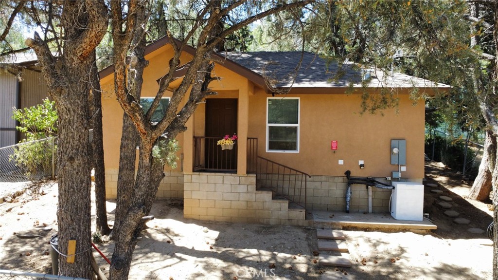 BUYER RECEIVES A 1-YEAR COMPLETE HOME WARRANTY WITH THE PURCHASE OF THIS HOME! Our favorite features of this property include: A MODERN MOUNTAIN RETREAT IN THE PINES, A BONUS ROOM, AND AN UNBEATABLE PRICE AT JUST $225,000! Don’t miss this incredible opportunity to own a beautifully maintained home, built in 2018, and perfectly nestled among peaceful pine trees on a fully fenced lot. This rare gem offers one bedroom plus a versatile bonus room, ideal for a home office, guest space, or creative studio. Step inside to a stylish kitchen featuring granite countertops, a brand-new stove, and a stainless-steel refrigerator. Durable tile flooring runs throughout the home, giving it a clean and modern look that’s both functional and low maintenance. A full fire sprinkler system provides added safety and peace of mind. Additional highlights include a paid-off Tesla charger, a handy storage shed, and flexible parking options, inside the gated yard or conveniently on the street. Whether you're searching for a quiet retreat, a starter home, or an income-producing rental, this move-in-ready mountain home offers exceptional value at just $225,000. Schedule your tour today, this one won’t last!