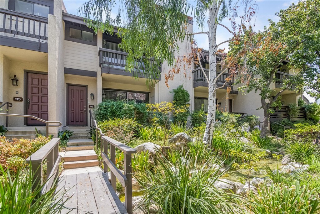 Welcome to this lovely tri level townhome located in Woodland Hills. There are 3 bedrooms & 2.5 baths plus a large bonus room downstairs that can be used as an office, den, playroom or storage. As you step in from the front door, you are greeted by a large living room with a cozy fireplace and a front deck with sitting area. This bright and open floor plan includes a spacious dining area with a wet bar, gleaming hard wood floors, a great cook’s kitchen complete with all the appliances, recessed lighting, plenty of cabinets & counter space and a breakfast nook next to a glass slider and balcony. All the bedrooms are spacious and bright especially the primary suite with vaulted ceilings, a walk-in closet and access to its own private balcony overlooking the Zen-like outdoors with a running stream and lush greenery. Not to mention newly painted, new carpets & an attached 2 car garage with direct access to the unit. Situated on a meticulously maintained complex with walking paths throughout surrounded by gorgeous landscaping & resort style amenities like tennis courts, pool & spa. Conveniently located minutes away from shopping centers, numerous restaurants, parks and freeway access!