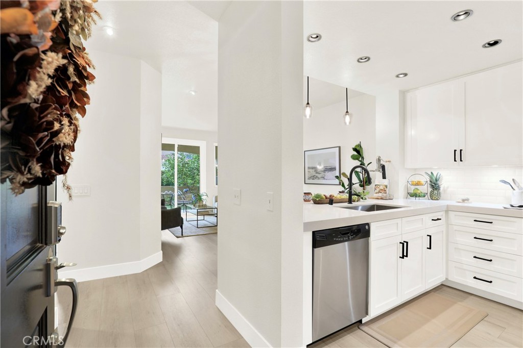 UPGRADED Turnkey Single-Level Condo in Aliso Viejo. Welcome to a beautifully updated two-bedroom, two-bathroom home in the tranquil Seacrest Villas community, situated above the AV Country Club with panoramic Saddleback Mountain views. Recognized as the 2nd safest city in California, Aliso Viejo offers peace of mind along with a coastal suburban environment. This prime location home showcases a modern design with upgrades throughout including luxury vinyl flooring, shaker-style bedroom and bathroom doors, updated cabinetry, quartz countertops, and custom marble tile showers with sleek glass enclosures. Additional highlights include central a/c, indoor laundry, direct-access garage with ample storage, additional assigned parking spot and a partially secluded patio with fruit trees—perfect for gardening, relaxing, entertaining or morning yoga. Seacrest Villas residents enjoy a resort-style pool and spa along with the reassurance of the entire community PEX re-piped completed in 2023 for added value. Ideally located near dining, shopping/TJ Maxx/Trader Joes, Capistrano Unified School District, hiking and biking trails, impeccably landscaped parks, world-class beaches, Soka University and Performing Arts Center and convenient freeway and toll road access. This home offers an ideal blend of comfort, convenience, and the South Orange County lifestyle.
