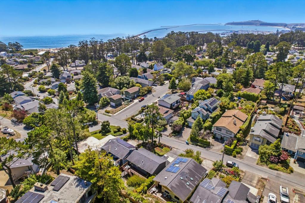 Welcome to 422 Avenue Portola, where coastal comfort meets versatile living. This spacious split-level gem located in the heart of sunny El Granada, the "banana belt" of the Coast, features 3 bedrooms and 1 full bathroom upstairs. This home boasts hickory wood floors, recessed lighting, and a beautifully updated kitchen with quartz countertops and stainless steel appliances. Step out onto the upper-level back deck to enjoy peek-a-boo ocean views and your morning coffee in the fresh coastal air. Downstairs, discover a thoughtfully designed 1-bedroom, 1-bathroom suite complete with a second living room and cozy fireplace perfectly suited as a private in-law unit or guest quarters. Whether you're hosting family or seeking rental potential, this flexible layout offers endless possibilities. Located just minutes from Surfer's Beach, the Coastal Trail, Pillar Point Harbor, and Quarry Park, outdoor enthusiasts will love the proximity to hiking, mountain biking, and ocean adventures. With easy access to Highway 1, commuting to San Francisco, Silicon Valley, or SFO is a breeze. Don't miss your chance to own a slice of coastal living with built-in versatility and charm.