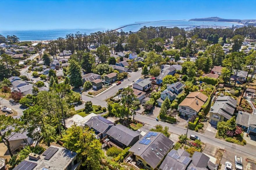 Welcome  to 422 Avenue Portola, where coastal comfort meets versatile living. This spacious split-level gem located in the heart of sunny El Granada, the "banana belt" of the Coast, features 3 bedrooms and 1 full bathroom upstairs. This home boasts hickory wood floors, recessed lighting, and a beautifully updated kitchen with quartz countertops and stainless steel appliances. Step out onto the upper-level back deck to enjoy peek-a-boo ocean views and your morning coffee in the fresh coastal air. Downstairs, discover a thoughtfully designed 1-bedroom, 1-bathroom suite complete with a second living room and cozy fireplace perfectly suited as a private in-law unit or guest quarters. Whether you're hosting family or seeking rental potential, this flexible layout offers endless possibilities. Located just minutes from Surfer's Beach, the Coastal Trail, Pillar Point Harbor, and Quarry Park, outdoor enthusiasts will love the proximity to hiking, mountain biking, and ocean adventures. With easy access to Highway 1, commuting to San Francisco, Silicon Valley, or SFO is a breeze. Don't miss your chance to own a slice of coastal living with built-in versatility and charm.