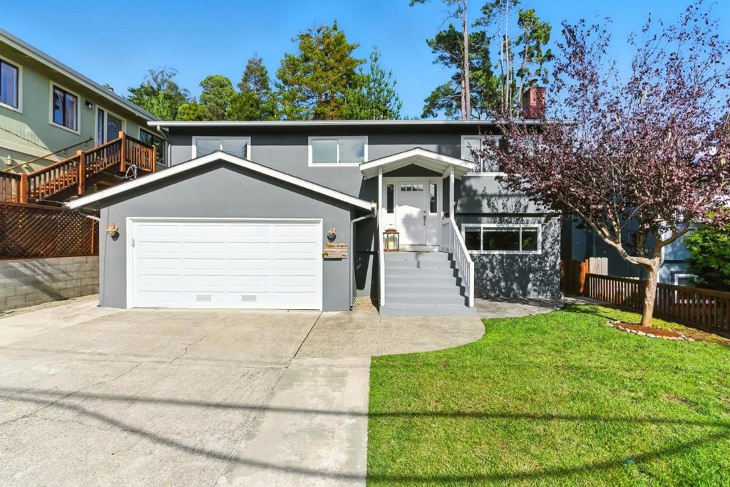 Welcome to 422 Avenue Portola, where coastal comfort meets versatile living. This spacious split-level gem located in the heart of sunny El Granada, the "banana belt" of the Coast, features 3 bedrooms and 1 full bathroom upstairs. This home boasts hickory wood floors, recessed lighting, and a beautifully updated kitchen with quartz countertops and stainless steel appliances. Step out onto the upper-level back deck to enjoy peek-a-boo ocean views and your morning coffee in the fresh coastal air. Downstairs, discover a thoughtfully designed 1-bedroom, 1-bathroom suite complete with a second living room and cozy fireplace perfectly suited as a private in-law unit or guest quarters. Whether you're hosting family or seeking rental potential, this flexible layout offers endless possibilities. Located just minutes from Surfer's Beach, the Coastal Trail, Pillar Point Harbor, and Quarry Park, outdoor enthusiasts will love the proximity to hiking, mountain biking, and ocean adventures. With easy access to Highway 1, commuting to San Francisco, Silicon Valley, or SFO is a breeze. Don't miss your chance to own a slice of coastal living with built-in versatility and charm.