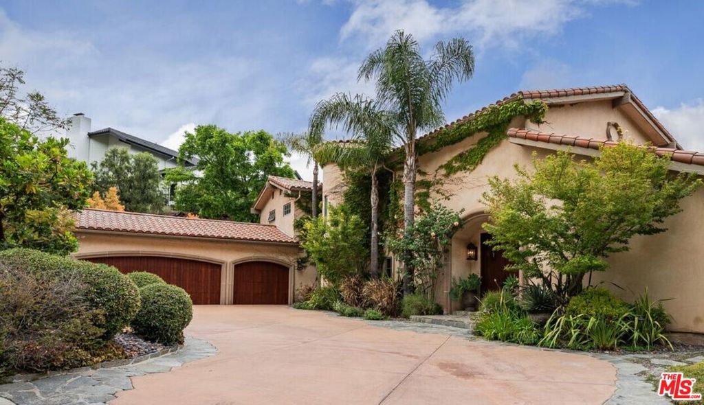 Welcome to this stunning, designer-furnished residence in the exclusive, 24-hour guard-gated Palisades Country Estates. Situated on over half an acre with 200 feet of street frontage and adjacent to state parkland, this home offers breathtaking panoramic mountain views and exceptional privacy. Featuring approximately 3,800 square feet of living space, the property has been thoughtfully upgraded with over $1 million in improvements since 2003. Renovated for seamless indoor-outdoor living, the home includes five bedrooms (one currently used as a high-end office) and four and a half bathrooms. The main living room boasts vaulted, beamed ceilings, a large fireplace with a stone mantelpiece, and curated, museum-quality artwork, including pieces by Baldessari, Dali, and Kandinsky. The formal dining room showcases artisan-crafted dining sets, a new designer chandelier, and custom furnishings. The chef's kitchen was remodeled in 2019 and includes Sub-Zero refrigeration, deluxe double ovens, a gas range, custom cabinetry, a hidden coffee station, and a pass-through window to the outdoor bar. Additional features include a spacious family room with custom banquette seating, a designer sectional, a high-end sound system, and floor-to-ceiling sliders leading to the backyard. The primary suite offers vaulted ceilings, a private terrace with expansive views, a California king bed, surround sound, and a newly renovated spa-style bathroom with heated floors, marble counters, a soaking tub, a separate shower, and double sinks. Three additional upstairs bedrooms are fully furnished with Pottery Barn and West Elm pieces and feature updated California closets. One bedroom includes an en-suite bath and a private terrace. Throughout the home, you'll find hardwood floors, extensive built-ins, curated art, a wine cellar for 400+ bottles, and a fully renovated wet bar with black marble counters. The expansive backyard features a pool and spa with a new pebble tech finish and designer tile (2025), a firepit lounge area, a built-in outdoor BBQ and stone bar, a teak dining table with a built-in heater, multiple lounge zones, garden beds, mature fruit trees, and a large grassy area. The home is pet-friendly, with a dog run and fenced yard. The garage features resurfaced flooring, cabinets, a work desk, weights, and a ping pong table. Please note that the garage or portions thereof may be excluded from the lease. The residence also includes multi-zone HVAC, solar panels, central vacuum, high-speed Wi-Fi, and Sonos throughout. The lease includes access to the nearby Palisades Recreation Association park, featuring sports fields, playgrounds, picnic areas, and a dog park with designated hours. Following the fire, the home underwent a thorough deep clean by Serv-Pro, which included duct replacement, insulation replacement, and professional cleaning of all surfaces, rugs, and draperies. Available fully furnished for lease in early August.