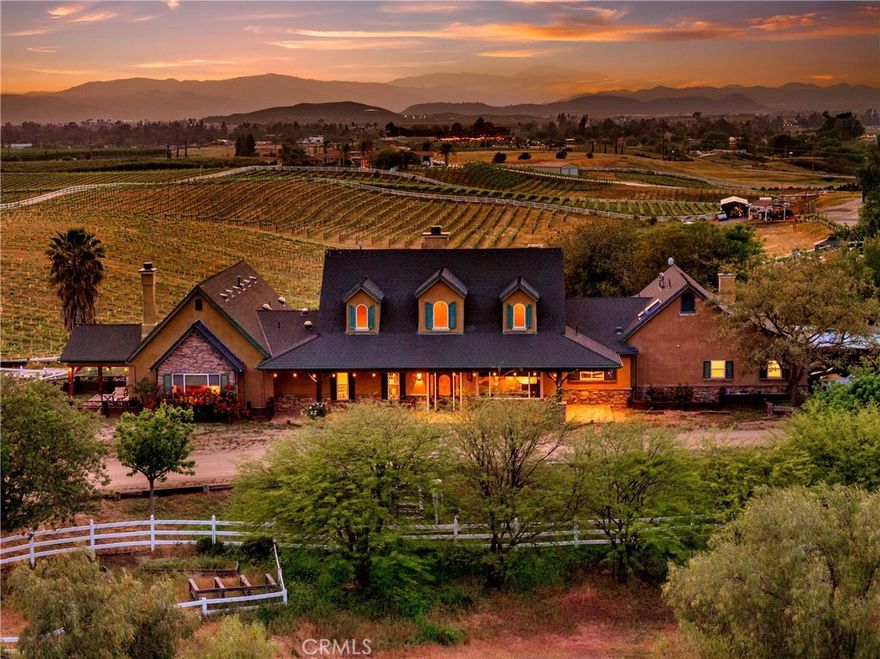 Welcome to Peppertree Lane Ranch, a rare 7-acre vineyard-wrapped retreat where privacy, luxury, and effortless indoor/outdoor living come together. Morning hot-air balloons drift overhead; evenings bring quiet sunsets over the vines. Three turnkey residences, resort-style amenities, and extensive equestrian facilities create a setting unlike anything else in Temecula Valley Wine Country.THE MAIN RESIDENCE (4bd/4ba) blends custom stone, wood, and ironwork with true SoCal indoor/outdoor living. A chef’s kitchen with Viking appliances and oversized island opens to an accordion-glass wall for seamless entertaining. Enjoy a pool and spa framed by vineyard views, a spa-style primary suite with covered patio, a second master suite with its own turfed lawn, and a three-car garage.THE COTTAGE (2bd/2ba) near the property entrance offers its own garage, grill area, hammock, bocce court, and picnic space – perfect for guests or weekend getaways.THE VILLA building provides four individually keyed king suites with a shared lobby, each with custom stone grotto showers. The adjoining recreation area includes grills, picnic tables, fire pit, and bocce court.*** Horse lovers will appreciate 15 Stalls with covers, very well built, varying sizes w/a minimum of 18’ x 20’, 60' round pen, a lighted arena (225’ x 125’)with sound and covered seating, and privately gated access to miles of vineyard trails.*** Plenty of room for vineyards, farm animals, organic gardens, fruit trees or recreation areas.*** Smart-enabled access, mesh WiFi throughout, and exceptional multi-use potential – personal estate, family compound, equestrian center, boutique hospitality, wellness retreat, or creative hideaway. Offered unfurnished; furnishings available.** This property MUST BE EXPERIENCED IN PERSON to appreciate its setting, craftsmanship, and versatility; schedule a tour today.