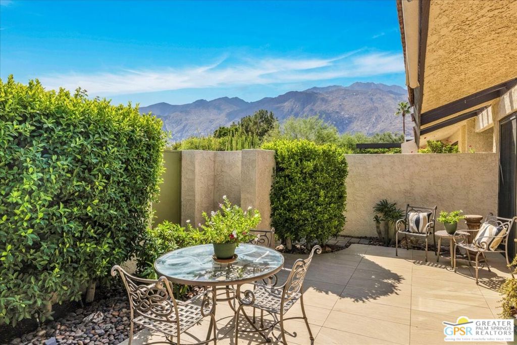 Welcome to the heart of Palm Springs! From the moment you step inside, you'll be captivated by spectacular mountain views enjoyed from both the living room and the private courtyard. The inviting living area is anchored by a charming fireplace, creating a warm focal point for gatherings. Throughout the home, gorgeous tile floors flow seamlessly from room to room and extend outdoors into the courtyard, enhancing the indoor-outdoor lifestyle Palm Springs is known for. Large sliding doors and windows were replaced, allowing natural light to flood the interior while improving efficiency and style. The kitchen is designed for both everyday convenience and entertaining, offering a bar counter for casual dining as well as a generously sized dining room ideal for hosting dinner parties. The Primary Suite features a custom-designed closet and direct access to the private courtyard, while the split-bedroom layout ensures privacy for guests in their own comfortable suite. Outdoor living is a true highlight, with a very private walled courtyard perfect for morning coffee, evening cocktails, or entertaining under the stars. Parking is exceptionally convenient with multiple options: curbside parking on Andreas right in front of the unit, a one-car garage with built-in storage cabinets and closets, plus a designated parking bay located directly at the unit. This home is truly move-in ready, combining modern upgrades, functional design, and the perfect central Palm Springs location. Whether you're searching for a full-time residence, a seasonal escape, or a stylish investment property, this condo delivers the best of desert living.