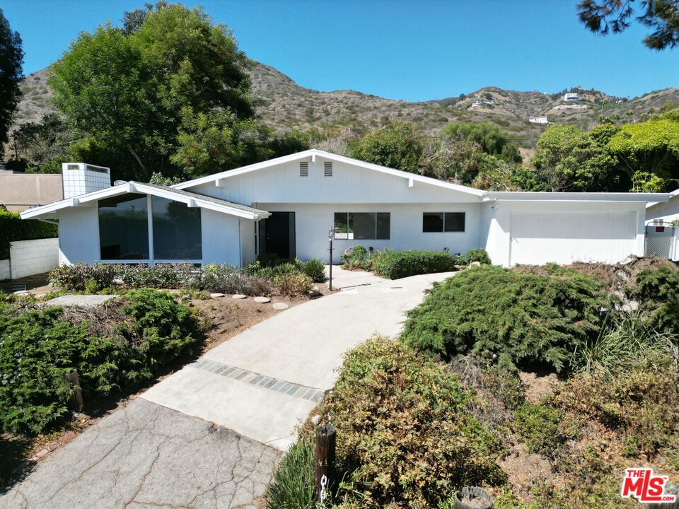 Coastal Lease with pool, across from Sea Level Beach, Situated in the Broad Beach neighborhood, this single-level residence offers comfort and coastal living. Featuring 3 bedrooms and 2 bathrooms, the home has terrazzo floors and a high-beamed ceiling with an open floorplan. Peek a Boo Ocean views from Kitchen and Livingroom and a private drive with 2-car garage ensures ample parking and storage. Across the street from Sea Level Beach, this property offers convenient access to Malibu's shoreline.