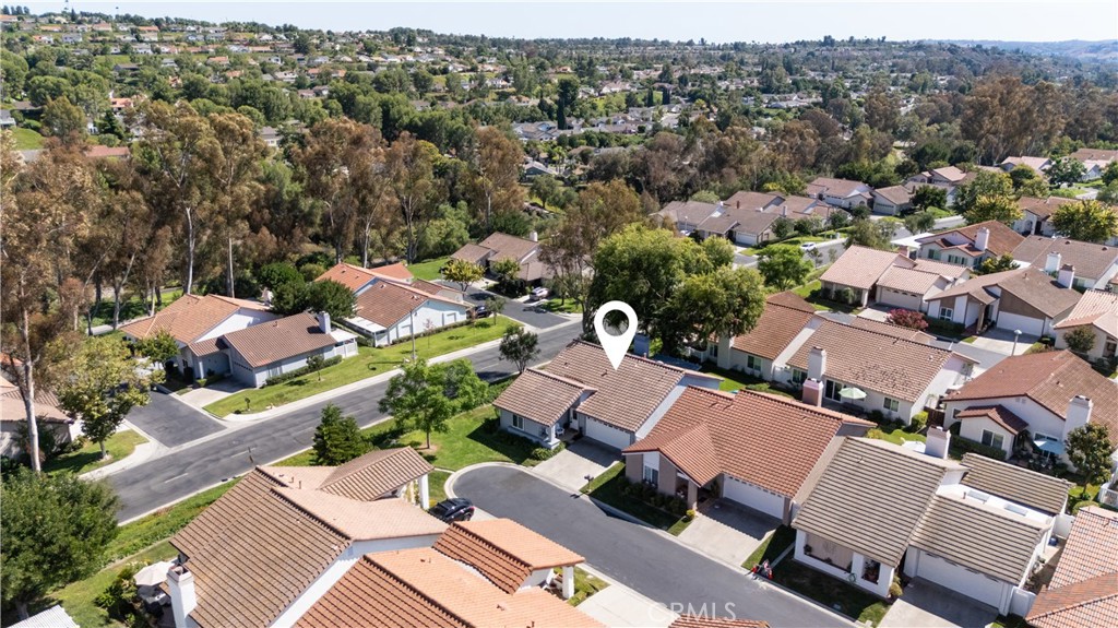 Nestled at the end of a quiet cul-de-sac within the scenic 55+ guard-gated community of Casta del Sol, this fully remodeled home offers resort-style living with stunning hillside views and gorgeous sunsets. The open, light-filled floor plan features luxury vinyl plank flooring throughout the main level, which includes a convenient ground primary bedroom, secondary bedroom currently staged as an office and two fully remodeled bathrooms providing true single-level living. As a bonus, upstairs offers a secondary primary bedroom with a full bathroom and three closets! The heart of the home is a modern gourmet kitchen featuring a tile backsplash, numerous cabinets, and a large island with quartz countertops that flows seamlessly into the family and dining room which includes a brand new built-in bar with cabinets, quartz counters and a beverage refrigerator. Enjoy outdoor living on two separate patios, including an intimate western patio with a natural gas hookup and a larger southern patio with sweeping valley views. Other key features of this beautifully updated property include new plumbing, new windows, LED recessed lighting, and a newer HVAC and water heater. The 2-car attached garage offers plenty of built in cabinets with storage, including storage under the stairs. Casta del Sol offers an active lifestyle with community amenities like pools, recreation centers, golf access, social clubs, greenbelts, and exclusive membership to Lake Mission Viejo, all with a low 1% tax rate and no Mello Roos. This turnkey home won't last long!