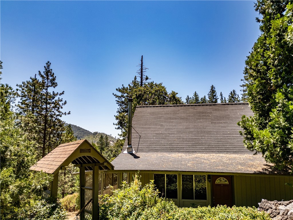 Beautifully remodeled A-Frame in Ponderosa Basin. Enjoy the peaceful setting and mountain views from this cute country cabin. Step inside and you will be struck by the wood beamed ceiling, the cozy wood stove, fully remodeled kitchen, and brand new bathrooms. The flooring throughout has been upgraded with a luxury vinyl plank for maintenance free beauty. This would make a great weekend getaway from the hustle and bustle of the city, or an amazing residence if you're able to move to the mountains full time. County records show a 1440 square foot 2/2, but there is clearly a 3rd bedroom upstairs, and the garage build that was started, was never completed and the previous owners converted it to living space, with laundry hookups and enough space for a kids play room or an art studio. This adds 332 square feet to the home, to bring the total to 1772 square feet. Nestled on an almost 1 acre lot, you'lll have privacy from the neighbors while enjoying your view from the screened in porch, or the upper level living area. Ponderosa Basin is also a desirable vacation rental location, so you can investigate what would be needed to meet county requirements to apply for your vacation rental permit, and establish a high performing Airbnb, either full time or when you're not using it as a second home.