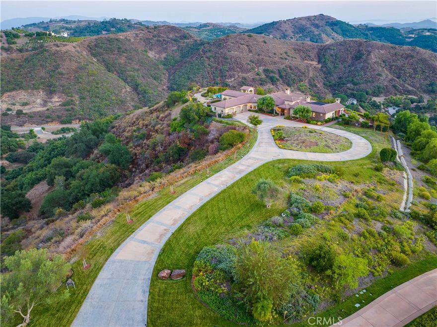 Breathtaking Panoramic Picturesque Views of Surrounding Hills and Valleys, Tranquility and Privacy. Elegant and Timeless De Luz Residence Impeccably Maintained and Beautifully Curated. Located Just Minutes from Historic Old Town Temecula (EST. 1859) and Temecula Wine Country. Stunning Drive Through Del Luz Roads with Majestic Oak Trees and Orchards, Adding Charm and Almost Magical Sense. On a Clear Day You Can Catch a Glimpse of Ocean View before heading Down Large Private Circular Driveway, and if you look left, during the Winter and Spring You Might see the Snow of San Bernardino National Forest. Impressive and Inviting Curb Appeal. Welcoming Front Porch, Lead Glass Double Door and Cathedral Ceiling Entry. Living Room with Curved Wall Enhancing Stunning Views. Gleaming Oil Rubbed Oak Flooring Throughout, Open Floor Plan Flooded with Natural Light. Formal Dining Room Adjacent to Gourmet Kitchen that Includes Oversized Center Island, Butler's Pantry, Wine Cellar, Walk-In Pantry and Spacious Breakfast Nook. Kitchen Opens to Incredible Family Room with Remarkable Beams, Fireplace and Two Sets of French Doors Leading to Covered Patio. The Primary Suite Includes Fireplace, Two Oversized Walk-In Closets and Large Retreat/Library that can be easily turned into a Fifth Bedroom, Nursery or Gym. Adjacent to the Primary Suite is also Spacious Office with Two Built-In Desks. The Left Wing of this Extraordinary Home Comprises Three En-Suite Bedrooms, All Offering Truly Magnificent Views. Resort Style Backyard Includes Several Patios, Swimming Pool, Spa, BBQ Island, Horseshoe Pit, Mega Chess Board and So Much More! Fruit Tree Orchard Includes Several Citrus Trees, Avocado and Passion Fruit Tree and 15 Crepe Myrtle Trees are Planted Along the Private Driveway. Oversized Three Car Garage Includes Epoxy Flooring, Electric Car Charger and Ample Storage. Long List of Amenities and Recent Upgrades Available Upon Request. Truly Remarkable Property; Four Bedrooms, Retreat, Office, Four Fireplaces and Six Bathrooms Plus an Outdoor Shower. Low Property Tax Rate.