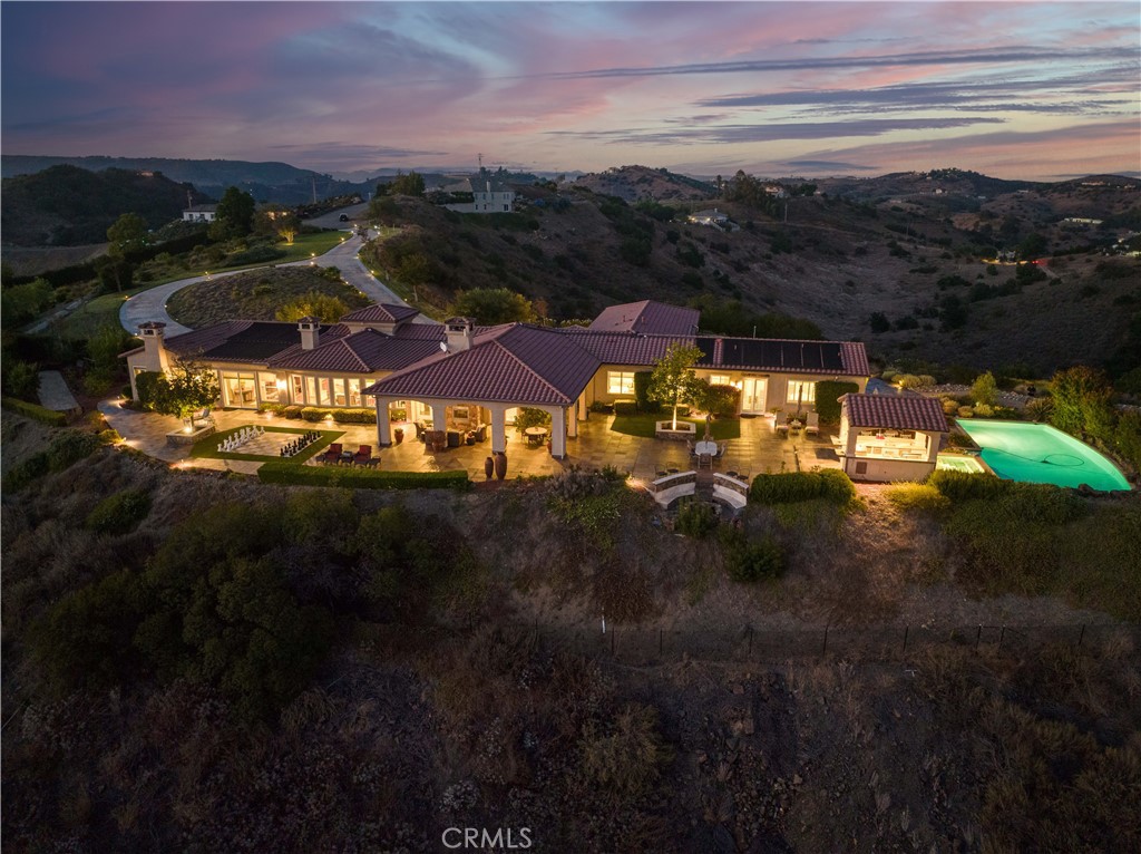 Breathtaking Panoramic Picturesque Views of Surrounding Hills and Valleys, Tranquility and Privacy. Elegant and Timeless De Luz Residence Impeccably Maintained and Beautifully Curated. Located Just Minutes from Historic Old Town Temecula (EST. 1859) and Temecula Wine Country. Stunning Drive Through Del Luz Roads with Majestic Oak Trees and Orchards, Adding Charm and Almost Magical Sense. On a Clear Day You Can Catch a Glimpse of Ocean View before heading Down Large Private Circular Driveway, and if you look left, during the Winter and Spring You Might see the Snow of San Bernardino National Forest. Impressive and Inviting Curb Appeal. Welcoming Front Porch, Lead Glass Double Door and Cathedral Ceiling Entry. Living Room with Curved Wall Enhancing Stunning Views. Gleaming Oil Rubbed Oak Flooring Throughout, Open Floor Plan Flooded with Natural Light. Formal Dining Room Adjacent to Gourmet Kitchen that Includes Oversized Center Island, Butler's Pantry, Wine Cellar, Walk-In Pantry and Spacious Breakfast Nook. Kitchen Opens to Incredible Family Room with Remarkable Beams, Fireplace and Two Sets of French Doors Leading to Covered Patio. The Primary Suite Includes Fireplace, Two Oversized Walk-In Closets and Large Retreat/Library that can be easily turned into a Fifth Bedroom, Nursery or Gym. Adjacent to the Primary Suite is also Spacious Office with Two Built-In Desks. The Left Wing of this Extraordinary Home Comprises Three En-Suite Bedrooms, All Offering Truly Magnificent Views. Resort Style Backyard Includes Several Patios, Swimming Pool, Spa, BBQ Island, Horseshoe Pit, Mega Chess Board and So Much More! Fruit Tree Orchard Includes Several Citrus Trees, Avocado and Passion Fruit Tree and 15 Crepe Myrtle Trees are Planted Along the Private Driveway. Oversized Three Car Garage Includes Epoxy Flooring, Electric Car Charger and Ample Storage. Long List of Amenities and Recent Upgrades Available Upon Request. Truly Remarkable Property; Four Bedrooms, Retreat, Office, Four Fireplaces and Six Bathrooms Plus an Outdoor Shower. Low Property Tax Rate.