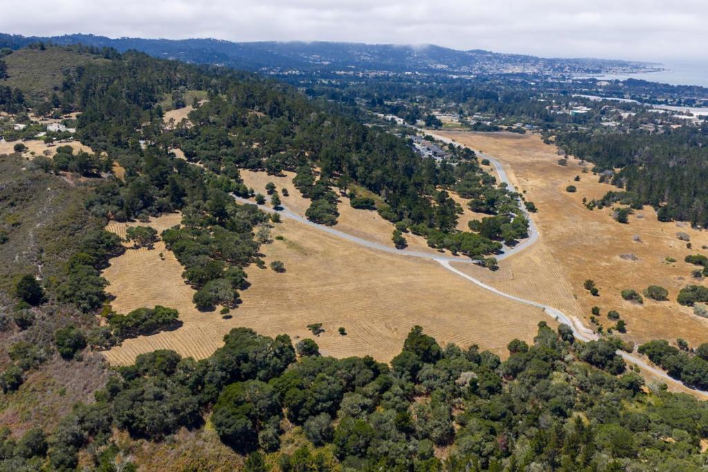 Discover a rare opportunity to own over 11± acres of gently sloping meadowland with ocean and mountain views within the exclusive gated community of Monterra Ranch. With a generous building envelope, this parcel offers the perfect canvas to design and build your dream estate amidst natural beauty and privacy. A natural spring enhances the land's appeal making it especially attractive for vineyard cultivation ideal for the wine enthusiast with a vision. This unique property also holds subdivision potential, presenting enticing development possibilities. Included with the sale is a coveted social membership to the renowned Tehama Golf Club, where members enjoy elegant and casual dining, year-round social events, and access to the state-of-the-art fitness center featuring two pools, tennis and pickleball courts, a weight room, and professional fitness classes and training. Take in sweeping views of the bay and surrounding hillsides, all just minutes from Carmel, Pebble Beach, and Montereys world-class golf courses, acclaimed restaurants, boutiques, galleries, scenic trails, beaches, the regional airport, and Laguna Seca Raceway offering sunny skies just beyond the coastal fog.