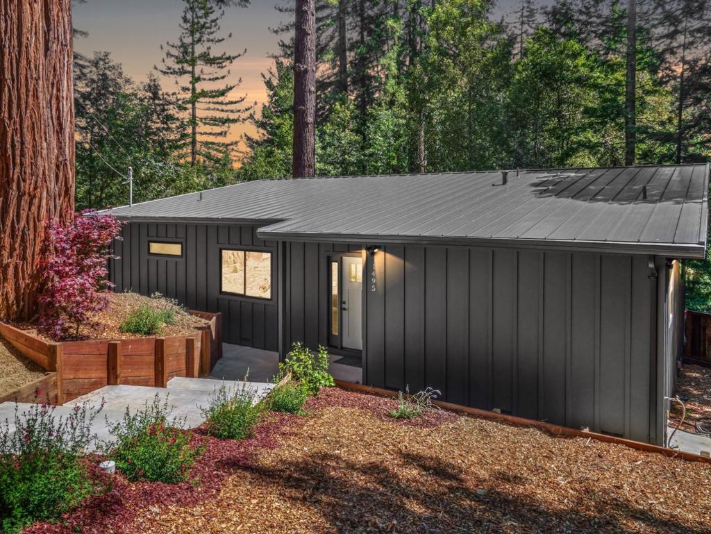 Major Price improvement! This is your opportunity to own a like brand new home! Welcome to 1495 McLellan Rd, a stunning modern like-new construction retreat tucked within the redwood-studded Forest Lake community of Felton. This fully remodeled 2-bedroom, 2-bathroom home offers 1,060 sq ft of bright, open-concept living space on a private half-acre lot. Designed with both comfort and style in mind, the home features vaulted ceilings, stainless quartz countertops, double-paned windows, heating & air conditioning unit, laminate flooring, and LED accent lighting throughout the interior and exterior deck. Enjoy your morning coffee on the front patio or entertain guests on the expansive deck surrounded by towering redwoods. This single-level property also features a brand-new septic system, adding to its turnkey appeal. A detached two-story building includes a one-car garage and a spacious upstairs office; ideal for remote work, hobbies, or guest overflow. Located just 7 miles from downtown Santa Cruz and with easy access to Silicon Valley, this home offers a perfect balance of privacy, design, and convenience.