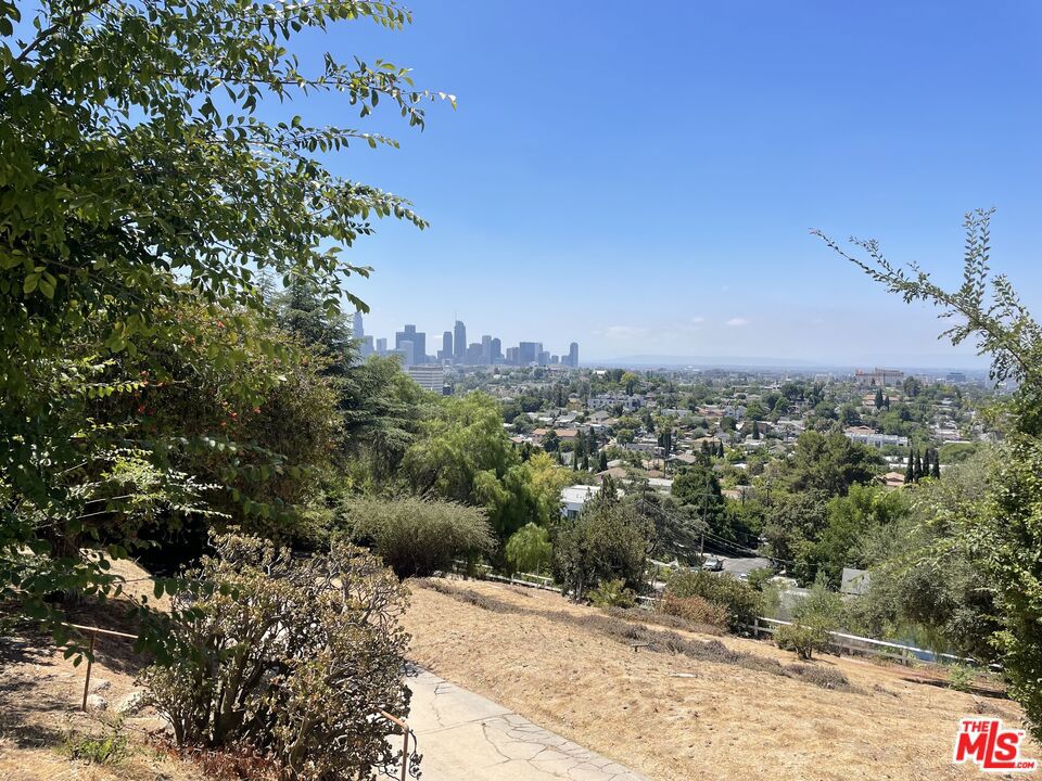 Live on Top of the World: A 1920s Echo Park Tuscan Villa with Panoramic Views. Discover a truly unique living experience in this enchanting 1920s Tuscan villa, gracefully perched high on an Echo Park hilltop. With breathtaking panoramic views in every direction, you'll find peace and inspiration in this private, plant and flower-filled oasis, reminiscent of a serene "Topanga" retreat. This incredibly spacious 3-bedroom, 1-bathroom downstairs apartment offers abundant privacy and its own dedicated outdoor space. Inside, you'll be welcomed by beautiful hardwood floors throughout and ceramic tile in both the kitchen and bath. Adorned with original charm and flooded with natural light, this unit is ready for immediate move-in. As part of a unique property featuring 5 total units and a guest bungalow, residents also enjoy full access to the building's shared rooftop and gardens, all overlooking the sprawling Los Angeles cityscape with stunning sunsets every evening. The convenience of two dedicated parking spaces completes this exceptional offering.