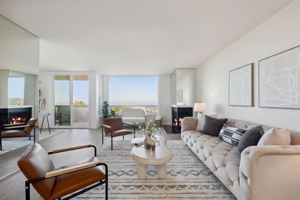 Discover unparalleled privacy and stunning, unobstructed views of the San Francisco Bay from this exceptional end unit at 320 Vallejo Dr #11 nestled in the hills of Millbrae. Spanning 1,249 sq ft, this bright and airy home welcomes you with abundant natural light streaming through large windows that frame the breathtaking scenery. The spacious living room with bonus den area is perfect for unwinding, with a sliding glass door leading to a private balcony where you can savor the views. Featuring two generously sized bedrooms, two bathrooms, and ample closet space, this move-in-ready unit includes convenient in-unit laundry, a deeded parking spot, and a storage locker in the secure garage. Recent updates enhance its appeal, while the community offers a lush greenbelt, walking trail and pool. The HOA fee covers amenities as well as water, hot water, garbage, and internet. Ideally located with easy access to top rated elementary, middle and high schools, Downtown Millbrae with its plethora of shops and restaurants, HWY 280/101 and Millbrae BART/Caltrain, this home combines luxury and convenience in a desirable setting.