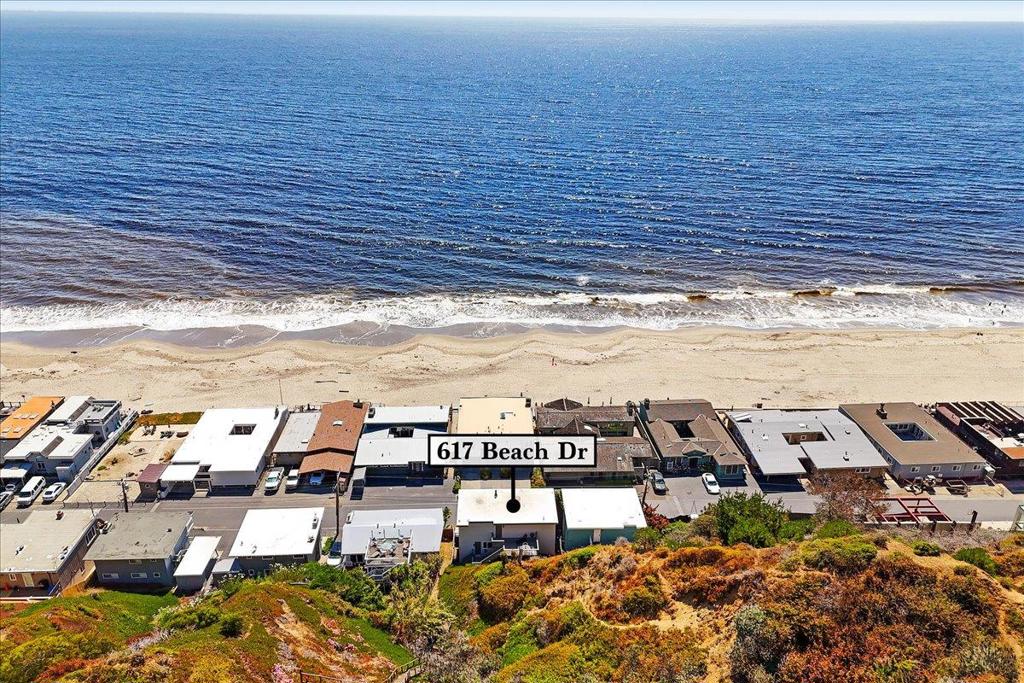 This charming coastal retreat offers sweeping Monterey Bay views from the kitchen, living room, and all 4 bedrooms. Located securely behind the gate in the Rio Surf & Sands community, the setting is unmatched. The great room showcases open-beam ceilings and a wall of glass that opens to the deck for effortless indoor/outdoor living. Kitchen, living, and dining flow together for easy entertaining and everyday comfort, and the floor plan provides excellent separation of space across three levels. Approximately 2,000 sq ft of living space plus a rare 3-car garage means plenty of parking and room for boards, bikes and beach gear. Positioned along the hillside across from the sand, the property, per seller, sustained no notable damage during the storm surges of the last two winters. From here you are minutes to Seacliff State Beach, Seascape Golf Course, and world-class hiking and mountain biking in The Forest of Nisene Marks State Park. Close to surf breaks, coffee, shopping, and dining - this isnt just a beach house - it is a launchpad for your Aptos lifestyle. Enjoyed by this family for over 30 years and surrounded by exceptional custom homes, the value and upside potential at this Beach Drive address are compelling.