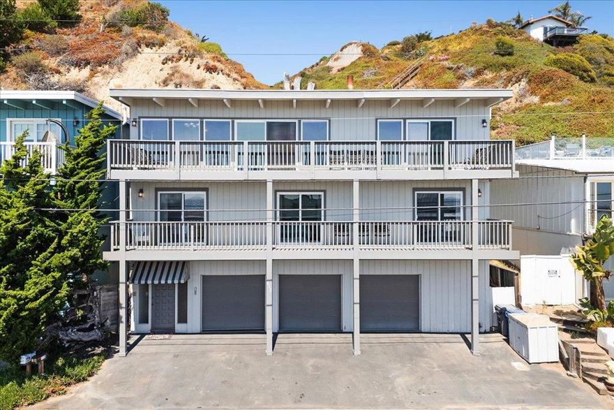 This charming coastal retreat offers sweeping Monterey Bay views from the kitchen, living room, and all 4 bedrooms. Located securely behind the gate in the Rio Surf & Sands community, the setting is unmatched. The great room showcases open-beam ceilings and a wall of glass that opens to the deck for effortless indoor/outdoor living. Kitchen, living, and dining flow together for easy entertaining and everyday comfort, and the floor plan provides excellent separation of space across three levels. Approximately 2,000 sq ft of living space plus a rare 3-car garage means plenty of parking and room for boards, bikes and beach gear.  Positioned along the gentle hillside, the property, per seller, sustained no notable damage during the storm surges of the last two winters.   From here you are minutes to Seacliff State Beach, Seascape Golf Course, and world-class hiking and mountain biking in The Forest of Nisene Marks State Park. Close to surf breaks, coffee, shopping, and dining - this isn't just a beach house - it is a launchpad for your Aptos lifestyle. Enjoyed by this family for over 30 years and surrounded by exquisite custom homes, the value and upside potential at this Beach Drive address are exceptional.