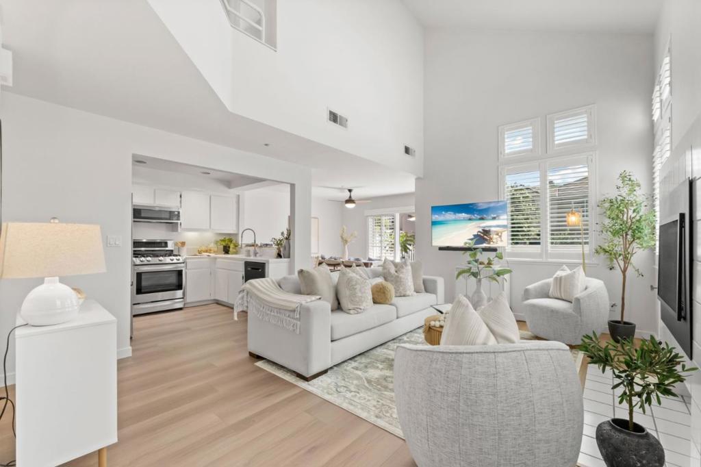 Discover this rarely available end-unit townhome, offering 3 bedrooms and 3 full baths across approximately 1,377 sf of refined living space. Bathed in natural light, the open-concept design combines comfort and sophistication, perfect for everyday living and stylish entertaining. The main level boasts a versatile bedroom and full bathideal for guests, multigenerational living, or a home office. The kitchen is appointed with tile countertops, premium stainless steel appliances, including a gas range, seamlessly connecting to the dining and living areas. Soaring ceilings, new luxury plank flooring, and a gas fireplace create an inviting ambiance. The enclosed dining patio provides a serene retreat with refreshing breezes and picturesque greenbelt views. Upstairs, the primary suite offers generous closet space and spa-inspired en-suite bath. Two additional baths feature both stall shower and shower-over-tub options, designed with convenience and comfort in mind. Additional features include central A/C and heating, in-unit laundry, and an attached one-car garage plus a permitted parking space. Residents enjoy resort-style amenities, including two sparkling pools and beautifully landscaped greenbelts. This home is just moments from shopping, dining, and access to major freeways.