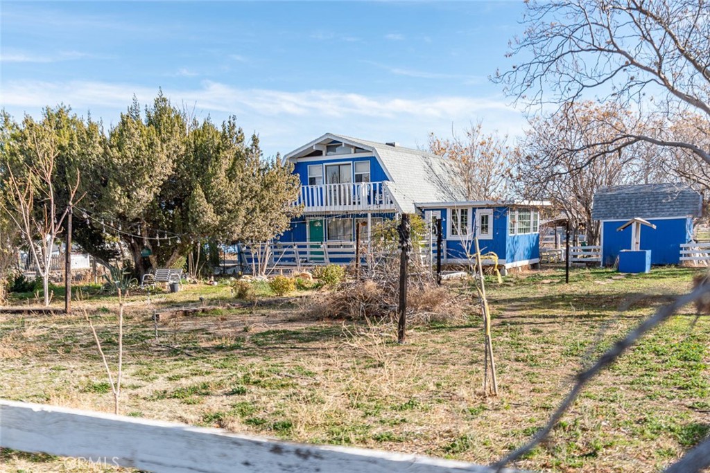 Discover this unique farm-style property in West Lancaster, offering two permitted homes on 2.39 acres with endless possibilities. The main residence is a charming 2-story ranch/cabin-style home featuring 3 bedrooms, 2 bathrooms, and approximately 1,700 sq.ft. of living space. It sits along 52nd Street and is surrounded by beautiful natural landscaping, plus a detached 2-car garage with a workshop area.
A separate 2+1 guest house of 768 sq.ft. fronts 51st Street, providing excellent privacy and flexibility for multigenerational living or rental opportunities. Between the two homes are three large metal storage buildings, perfect for equipment, vehicles, or hobby use.
Both homes are fully electric and equipped with newer heating and air systems. Located in a quiet, peaceful neighborhood while still close to shopping, schools, and city conveniences, this property blends rural tranquility with everyday accessibility.