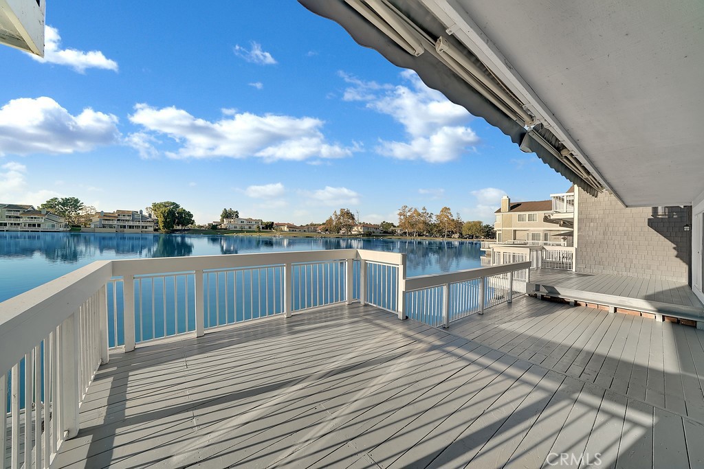 STUNNING WOODBRIDGE HOME WITH LAKE VIEWS AND GORGEOUS UPGRADES featuring two generous bedrooms, two baths, two-car garage, and oversized deck overlooking beautiful North Lake! DESIGNER UPGRADES Include elegant laminate floors, fresh paint, custom media built-in with pin-spot lighting, designer window coverings, Travertine surround fireplace, recessed lighting, and three sliding glass doors leading to spacious deck! SPARKLING KITCHEN Features ceramic tile countertops, upgraded appliances, built-in microwave, and dry-foods pantry. FABULOUS FLOWING FLOOR PLAN with private courtyard entrance, formal and nook dining areas, and convenient inside laundry. BATHROOM features Travertine floors and shower, upgraded chrome fixtures, upgraded cabinetry, custom mirror as well as custom light fixtures. PRIMARY SUITE features large walk-in closet as well as PRIMARY bath with dual sinks and soaking tubs! ENJOY Woodbridge Amenities!