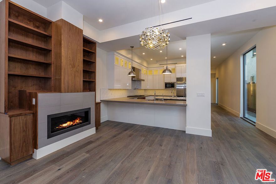 4-Bed, 4-Bath Modern Townhome with Rooftop Deck, Parking & Nearly 3,000 Sq Ft of Luxury Living. First floor features a powder room, laundry room, a custom cook's kitchen featuring two sinks, top-line appliances, quartz counters, large center island, tons of cabinetry, and walk-in pantry. First floor open living floor plan with lots of natural light opens directly to backyard creating a great entertaining space with surround sound speaker system. Second floor has 4 bedrooms, two of which have private balconies. Bedrooms have en-suite bathrooms, and high quality custom closets and woodwork. Each floor's HVAC is controlled by Nest. High-end craftsmanship and finishes with great attention to all details. As a unique bonus, the easily accessible rooftop deck has a great open entertaining area with a barbecue and breathtaking city views. Property has a video surveillance system. *1ST MONTH FREE PROMO - PRICE REFLECTS 12M SPREAD - BASE RENT $9,267*