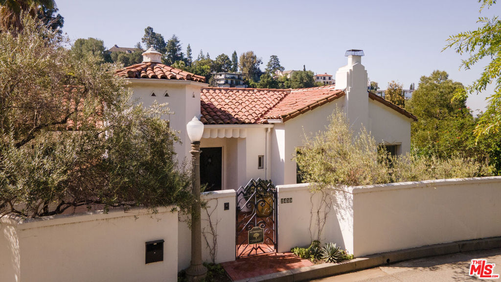 A Pristine Gem in the Exclusive Los Feliz Oaks. Step into a timeless piece of Los Angeles history. This exceptional Spanish-style residence is layered with rich Art Deco details, setting it apart as a true architectural treasure. From intricate tile work and hand-forged wrought iron to ornate ceiling designs, every element evokes the elegance of Hollywood's golden era. The primary suite boasts a walk-in closet and a beautifully preserved original tile bathroom. Throughout the home, you'll find hardwood floors, custom hardware, a steam room, a fully equipped gym, and French doors that open onto sun-drenched balconies. A highlight of the home is the Deco-style movie theater a cinematic masterpiece fit for a Hollywood premiere. Lovingly restored and thoughtfully enhanced by Nickey Kehoe, the home also offers lush canyon views and a private backyard retreat complete with a pool, spa, and outdoor kitchen. A rare offering of style, privacy, and old Hollywood glamour in one of L.A.'s most coveted enclaves.