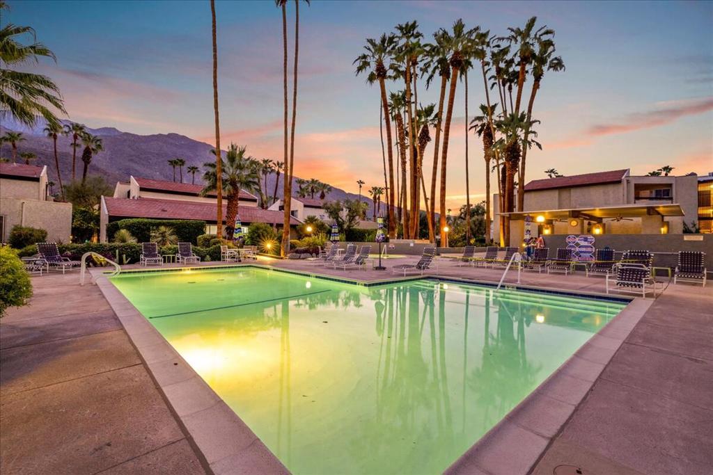 Discover resort-style living at Biltmore Phase II in South Palm Springs. Rarely available, single-story condo with Cathedral-style ceilings overlooking pool & spa. Adjacent to popular Deepwell neighborhood, this stunningly remodeled condo comes with a 1-car garage. Ground-level unit with private patio. Relax & enjoy serene garden views. Interior updated with attention to detail--fresh, modern finishes & fixtures. Open concept floorplan. Large living/dining area. Kitchen features stainless appliances, custom wood cabinetry, designer backsplash & easy-care countertop. Spacious primary with large closets & spa-like bath. Bathroom is accessible from hallway & primary. Tile flooring throughout with smooth finish ceilings. Custom light filtering window coverings. New appliances: stove, dishwasher, refrigerator, and in-unit washer/dryer stack. Newer: HVAC; front door (with mod crackle glass inserts); dual-pane windows & sliders; bath vanity, storage & shower conversion; garage overhead door; patio outlets & water heater. World-class attractions are just outside your door--ACE Hotel, Villa Royale, Koffi, iconic Downtown Palm Springs, hiking trails & more! Land is on lease by private lessor family (not a Native American land lease). This is the IDEAL refreshed condo to call HOME. Stop searching and START living!