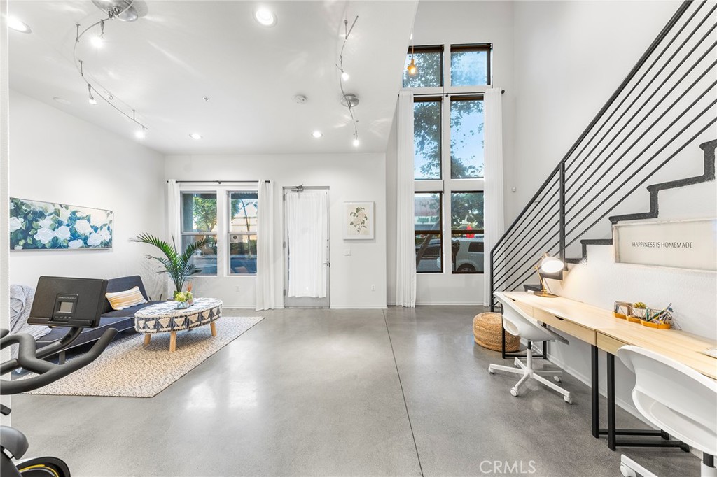 THIS IS THE LOFT YOU HAVE BEEN DREAMING OF!!! The Artist Walk Lofts are ideal for your living/office needs in Historic Downtown Santa Ana. Welcome to this Trendy home packed with High Quality Upgrades within walking distance to the most desirable California Top 10 High School - Orange County School of Arts. Steps through the front door and enjoy all this outstanding home has to offer. Soaring Ceilings in the main floor. Enormous Dual Pane Windows that Offer Lots of Natural Light, Polished Concrete Flooring, Custom roller Blinds, Exposed Duct Work, Designer Industrial-Style Fixtures & Accents, Recessed Lighting, Ceiling Fans, Newer Interior Paint, It Includes a Large Downstairs Studio or Living Room and Oversized Remodeled Bathroom, Plus Direct Access to Very Rare TWO-CAR "Finished" Garage with Storage Spaces.
Upstairs You'll Find Open Concept Living Areas that Includes Living Room, Dining Room, The Remodeled Gourmet Kitchen with Island Boasts Quartz Countertops, Newly Stainless Appliances (Dish Washer, Stove, Microwave), Stainless Sink, and Newly water heater.
Upgraded Full Bathroom with Quartz Countertops, newly bathtub and Dual Sinks. Open Bedroom Niches which can be Fully Enclosed. Sliding Glass Door that Opens to a Lovely Balcony.
Walking Distance to California TOP 10 High School OCSA -Orange Country School of the Arts.
Enjoy Nationally Recognized Restaurants & Museums & More! SCHOOL - WORK - LIVE - PLAY in DTSA!