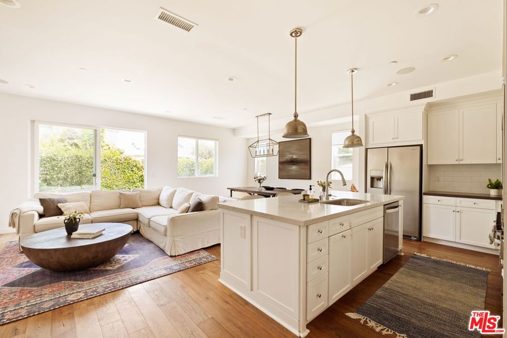 This bright, sun-filled 4-bedroom modern farmhouse is now available for lease, furnished or unfurnished. The open floor plan features high ceilings, European oak floors, an oversized fireplace, and seamless indoor-outdoor flow to a spacious backyard. The chef's kitchen centers around an expansive stone island with stainless steel appliances. The outdoor space is designed for Southern California living, with hardscaped lounge and dining areas, a built-in BBQ, mounted TV, grassy lawn, and two large dog runs. Upstairs, the primary suite includes a double vanity ensuite, soaking tub, and large walk-in closet, along with two additional bedrooms, a laundry room, and a sunny den that works well as a play/sitting area.The downstairs bedroom is currently configured as a dedicated office, while the finished garage with direct access can serve as a gym or studio.Smart home features include Nest doorbells and cameras, Sonos sound systems (indoor and outdoor), Nest-controlled HVAC for both levels, wireless garage controls, and a comprehensive security system. The property includes a fenced front yard with coded gate access.Located in a walkable neighborhood near Short Elementary, local coffee shops and restaurants, the Mar Vista Farmers Market, Marina, and beach.