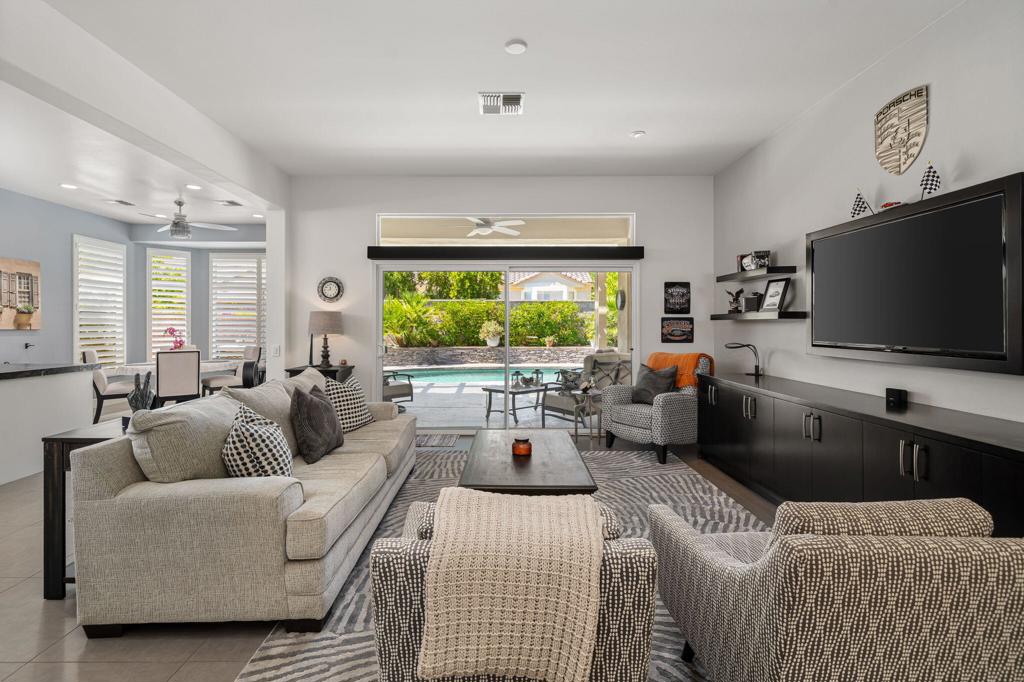Located in the heart of Sun City Palm Desert, this beautifully updated extended Tangier model offers resort-style living with a private saltwater pool, spa, and cascading waterfall, all surrounded by lush desert landscaping.Inside, the remodeled kitchen boasts quartz countertops, custom white cabinetry with pull-out shelving, and a designer tile backsplash. Plantation shutters throughout the home are complemented by upgraded LED accent lighting, creating a bright and inviting atmosphere.The floor plan includes a spacious primary suite with a custom walk-in closet, dual vanities, and a glass-enclosed shower, plus a guest bedroom with its own walk-in closet featuring custom cabinetry. A separate den provides flexible space for an office, hobby room, or additional guest retreat.The laundry room offers added storage convenience, while the extended garage is finished with epoxy floors, built-in cabinetry, golf cart parking, and a mini-split AC system.Recent updates include new pool equipment, a new pool pump motor, and a replaced condenser fan motor for the HVAC system, ensuring comfort and efficiency. Best of all, the home is being offered fully furnished--move-in ready from day one.This stylishly furnished home combines modern upgrades with the amenities of the Sun City lifestyle--perfect for full-time living or a desert retreat.