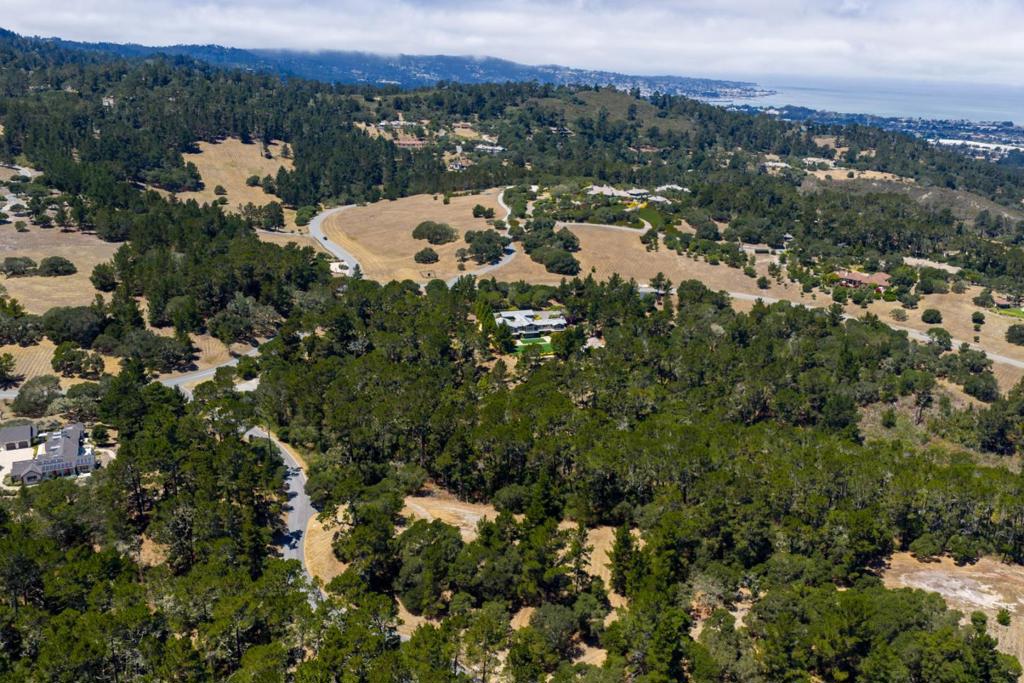 Located within the prestigious gated enclave of Monterra Ranch, homesite 116 offers 2.37± acres of serene privacy and natural beauty. Located on a quiet cul-de-sac, this property welcomes you with a gently sloping driveway that leads to a mostly level building pad. The expansive building envelope over three-quarters of an acre provides ample space to design and build your dream home. Surrounded by a majestic forest of mature pines and accented by stately oaks along the perimeter, this homesite offers a tranquil, park-like setting with calming views to a ridge line. Underground utilities are conveniently stubbed at the street, and private, paved roads ensure easy access throughout the community. Ideally situated just three miles inland from the coast, Monterra Ranch enjoys a sunny microclimate just beyond the coastal fog, while remaining only minutes from the beaches, fine dining, shopping, and cultural attractions of the Monterey Peninsula.
