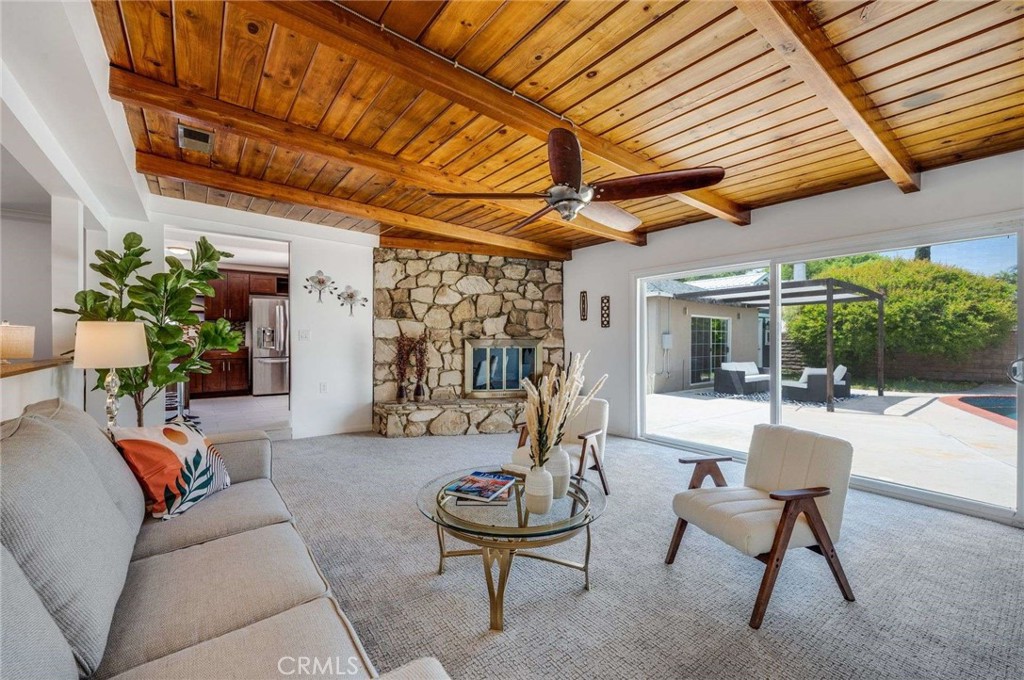 Classic mid-Century on tree-lined street on Lake Balboa border! Designed by legendary architect Charles DuBois, this modern 3 bedroom, 2.5 bath gem blends indoor and outdoor spaces seamlessly. The spacious step-down living room with statement fireplace and exposed wood ceilings opens out to spacious backyard with sparkling saltwater pool. Upgraded L-shaped kitchen with stone counters, modern appliances and plenty of storage. Lovely original hardwood floors. Detached garage is currently converted into a light-filled space with skylight, polished concrete floors and its own mini-split AC. An additional "loft house" also has its own AC. These two areas add over 450 sf of additional space for an office, yoga room, game room, child's playroom or guest bedroom. Lush, drought resistant front yard with drip system. EV charger conveniently installed by the driveway. Beautiful tree-lined street in quiet neighborhood close to Bertrand Elementary, and local restaurants such as Zig's and Golden City, and many more. In a "community lending" zone with grants possible for qualified buyers. Don’t miss it!