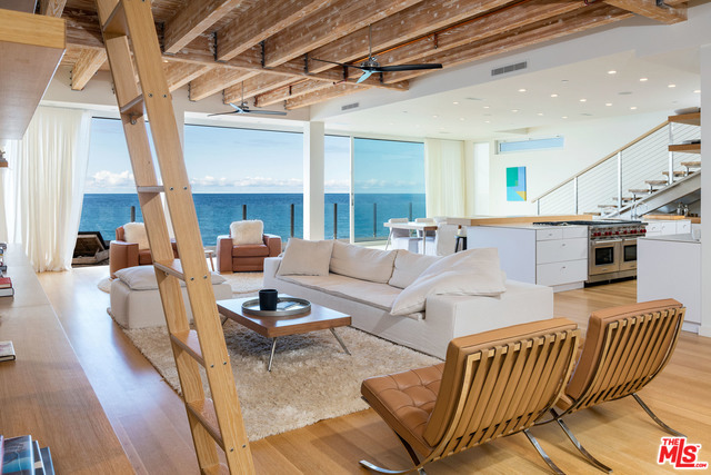 Come and experience the ultimate Malibu living with the highest quality available on the beach, designed by Scott Gillen/UNVARNISHED. Dramatic great room with exposed beam 12'+ ceilings, hand scraped oak floors and grand Fleetwood sliding glass doors. Custom gourmet kitchen with European Caesarstone counters and Wolf appliances. Stainless steel floating staircase leads to a 2nd large upstairs state-of-the-art media/living room. Ultra luxurious master suite with walls of glass opening to dramatic sunset and Point Dume views, private deck and large walk-in closet. Two other spacious guest suites upstairs and a 4th bedroom or office/gym downstairs. 2 car garage. This is one of Malibu Road's most spectacular properties.