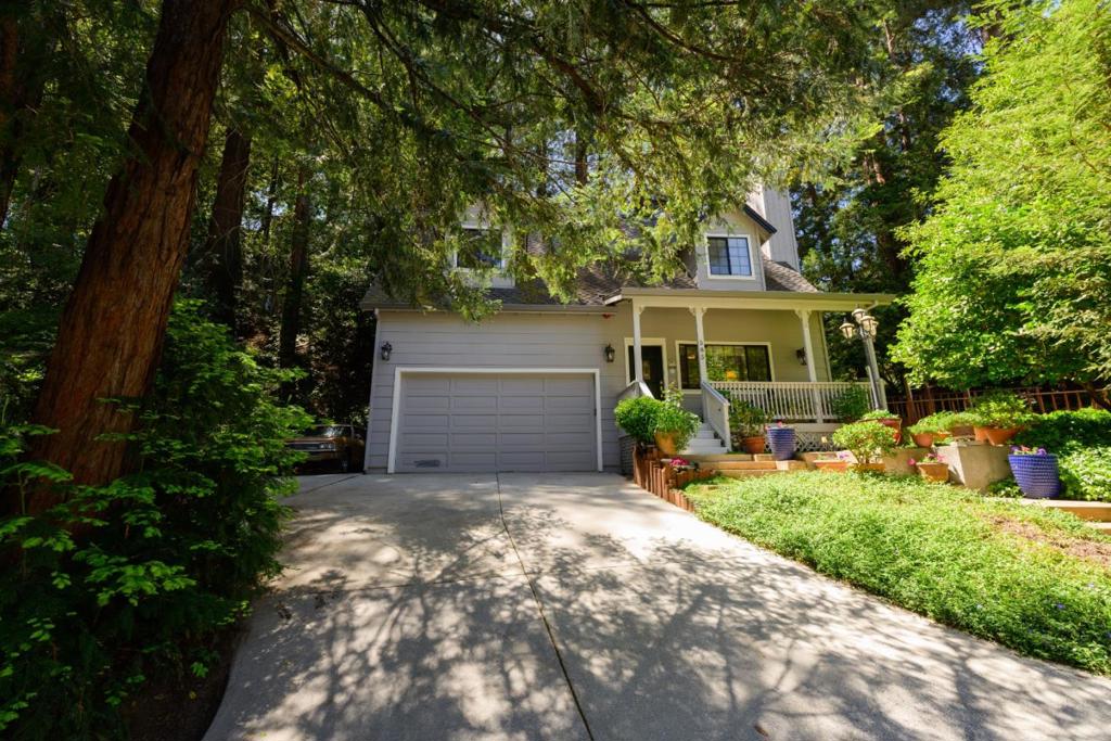 Beautiful home in picturesque setting! Located in the same neighborhood as the exclusive 1440 Mulitversity campus, surrounded by the natural beauty of the area. You will absolutely love this custom-built home w/ its sky-high wood-beamed ceilings, large bedrooms, & spacious kitchen and dining area. Located next to an open lot & only 1 block from the amazing trails of the Glenwood Preserve! The Living Room has gorgeous wood floors & an efficient wood-burning stove, surrounded by a welcoming brick hearth. Enjoy the open concept feel with also a nice separation of space between the kitchen, dining area, and family room. Just off the dining room, step outside to your secluded back patio, perfect for entertaining under the majestic Redwoods. The Primary Bedroom Suite is huge w/ high ceilings, cozy gas fireplace, sitting area, a spacious En Suite w/ two sinks, soaking tub, & separate shower. Walk out to your private deck overlooking the tranquil backyard. Two well-sized guest bedrooms & full guest bath are all on the same level as the primary suite. The home has many extras, like an indoor laundry room & built-in vacuum, and so much space for parking & storage in the enormous garage w/ extra-high ceilings & the side driveway large enough to park a small RV. 3 Minutes to Hwy 17!