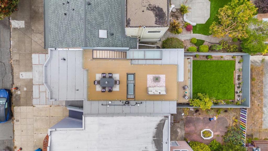 Experience this modern luxury design, meticulously renovated home in Inner Sunset. Step inside to a sun-drenched interior featuring white oak hardwood floors, expansive skylights, and architectural floating staircases with full glass railings, adding a sleek, open feel throughout the home.The gourmet kitchen, outfitted with a stylish island, sleek cooktop, built-in microwave, and seamless flow into the living and dining areas. A true highlight is the rooftop deck, accessible via a rain-sensor skylight system that blurs the line between indoors and out. Take in breathtaking panoramic ocean views ideal for relaxing,entertaining, or enjoying San Franciscos stunning sunsets.The primary suite offers a private retreat with a balcony, spa-like bathroom, and generous closet space. Enjoy whole house radiant heating, with individual thermostats on each level for year-round personalized comfort. On the lower level, a spacious family room with a wet bar opens through sliding patio doors to the backyard, perfect for indoor-outdoor living. An en-suite bedroom on this level offers flexibility for guests or multigenerational needs. Modern luxury, panoramic views, and a prime location this is more than a home, its a lifestyle. Dont miss the opportunity to make this Inner Sunset masterpiece yours.