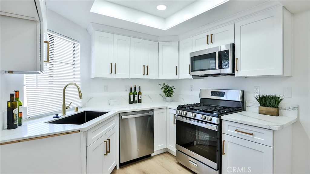 WOW!! Don't miss out on this beautiful, gorgeous townhome nestled in the heart of Little Saigon. Near lots of retail store, restaurants, freeway. As you enter, you will immediately notice all the details that makes this home stand out above the rest. Open floor plan, high elegant kitchen with recessed lights, elegant quartz, black stainless steel sink, state of the art stainless steel appliances, white shaker soft self closing drawer ...definitely a Chef's dream! Master bedroom have walk in closet and ensuite master bathroom with designs that is truly elegant . Wait there's more, each bedroom have it's own bathroom that is just insanely beautiful with exquisite tiles designs, modern vanity with quartz. There's also half bathroom downstair ! Modern light fixtures new modern hard flooring throughout. New central AC and Heater. There's a front patio with stucco wall for privacy, 2 car garage, laundry hook up in garage. HOA COVERS WATER & TRASH... this townhome have it all..... the list just goes on and on and on....put in your offer now .. will sell fast!!