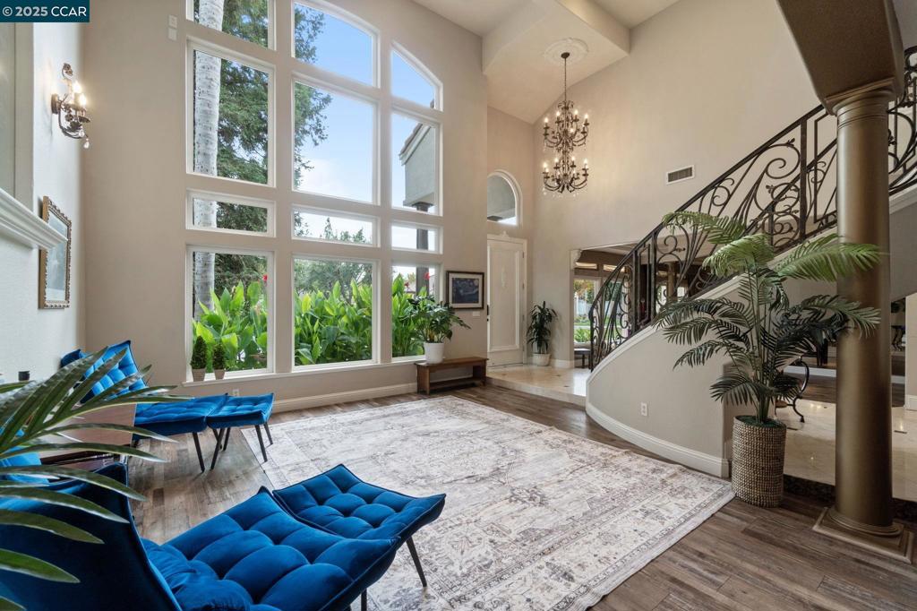 SHORTSALE OPPORTUNITY! Welcome to this custom masterpiece, where luxury & elegance blend seamlessly. The home greets you with dramatic, towering windows that nearly stretch from floor to ceiling, flooding the space with natural light and framing the grand entryway. Marble floors and a stunning marble staircase ascend beneath soaring ceilings accented by soft taupe tones and stately into the gourmet kitchen, where custom cabinetry, a crystal chandelier, and granite countertops are beautifully complemented by four layers of crown molding. This space flows effortlessly into the living room, featuring built-ins and a cozy fireplace, perfect for gatherings or relaxation. The first bedroom opens to a private balcony through French doors, complete with an ensuite bathroom. Two additional bedrooms share a thoughtfully designed Jack-and-Jill bathroom. The primary suite, set behind elegant double doors, is a sanctuary with its own fireplace, spa-like bathroom featuring a soaking tub, dual vanities, and two expansive walk-in closets. For added convenience, an upstairs laundry room awaits, along with a versatile garage space ideal for a workshop or gym. Outside, the backyard oasis invites you to unwind by the sparkling pool, complete with a cascading waterfall.
