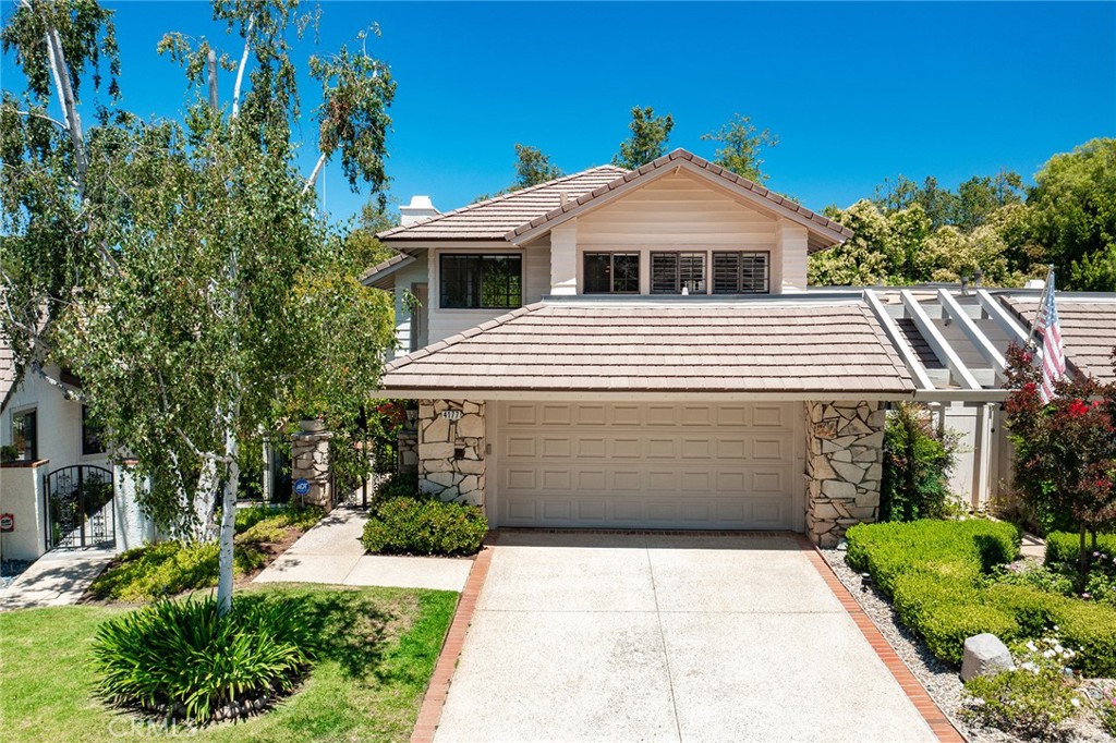 Immaculate highly upgraded North Ranch townhome that truly feels like a single family home located in the highly desirable Fairgreen Townhomes, a quiet cul-de-sac community that sits on the 5th Fairway of the North Ranch Golf Course. The property also has extremely rare private swimming pool & spa! The beautifully manicured front yard features wide driveway that leads to the 2-car finished garage with direct access. A gated front entry opens to a meandering pathway flanked by mature landscaping and a trickling water fountain. Inside you find a spacious entry foyer with convenient guest powder bathroom with new vanity that opens to an expansive sunlit living room boasting two-story soaring ceiling, mantled fireplace, and wall-to-wall windows with plantation shutters. The formal dining room has direct kitchen access and a remodeled wet bar with wine fridge, stone counters, and built-in soft close cabinetry. The separate living room has a stacked stone fireplace and large glass slider that opens to the yard ideal for indoor/outdoor flow. The upgraded kitchen has stainless appliances, double ovens, 5-burner stove with pot filler, granite countertops, pantry space with pullout drawers, and separate cozy breakfast nook overlooking the yard. Upstairs you will find a sprawling landing with abundant built-in storage and new stone counter. The luxurious primary suite features vaulted ceiling, new wide plank wood floors, mantled fireplace, cedar lined walk-in closet with second wardrobe closet, and private en-suite remodeled bathroom with built-in vanity, dual sinks, soaking tub, separate walk-in shower with multiple body sprays, and large picture windows. Two additional well appointed bedrooms are located on their own wing, each featuring new wide plank wood floors, custom closets, and they share a remodeled hall bathroom with new vanity and walk-in shower with skylight. An indoor laundry area has built-in storage cabinets and can fit side-by-side machines plus there is a separate walk-in storage closet/pantry. The entertainer’s backyard boasts swimming pool and spa, oversized covered patio with new ceiling fan and TV perfect for dining alfresco, new high end BBQ center with new black granite leather finished countertop, and private lush landscaping. Community amenities include a clubhouse, pool, spa, and the community is adjacent to North Ranch Country Club, Upper Ranch Park and great dining and shopping!
