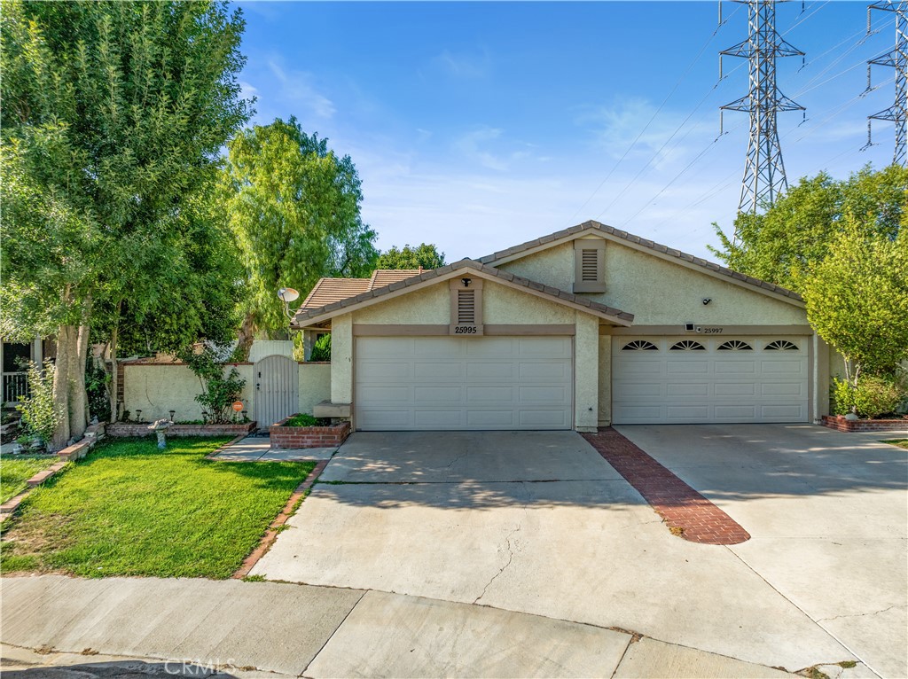Welcome to this charming single-story courtyard home, nestled on a quiet cul-de-sac in the desirable Sunrise tract of Valencia, California. Offering 3 bedrooms and 2 bathrooms, this residence boasts high ceilings, a cozy fireplace in the family room, updated Pex plumbing, a newer water heater, upgraded A/C unit, recessed lighting, and fresh interior paint completed this year. French doors off the kitchen open to a spacious backyard featuring a large grassy area—ideal for children, relaxing, barbecues, and gatherings with family and friends. Located in one of Valencia’s most sought-after neighborhoods, you'll enjoy easy access to parks, scenic paseos, community pools, and nearby destinations like Granary Square, Whole Foods, and a variety of popular restaurants, shops, and entertainment options. With a low HOA and no Mello Roos, this home offers the perfect blend of comfort, convenience, and value. Don’t miss out—schedule your showing today!