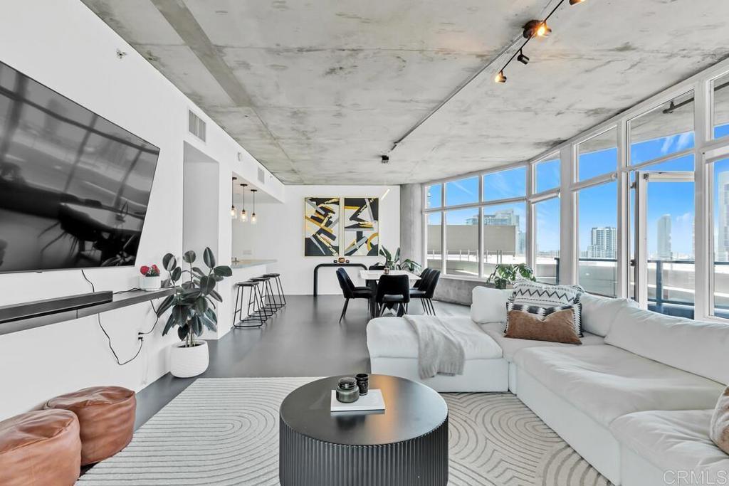 This expansive corner unit offers 2 bedrooms, 2 bathrooms, and 1,328 square feet of modern living in the heart of downtown San Diego’s East Village. With floor-to-ceiling windows, the home is filled with natural light and showcases sweeping city and Balboa Park views. The open-concept layout leads to a private balcony, perfect for entertaining or enjoying the skyline. Enjoy top-tier amenities including an on-site gym and an incredible rooftop deck featuring panoramic views, BBQ grills, and a spa. The unit includes two side-by-side assigned parking spaces in a secured garage—an increasingly rare feature downtown. Located just steps from Petco Park, the Gaslamp Quarter, UCSD’s downtown campus, and the trolley, this home delivers on walkability, lifestyle, and location. VA approved and move-in ready—ideal for first-time buyers, investors, or anyone seeking the best of downtown living.